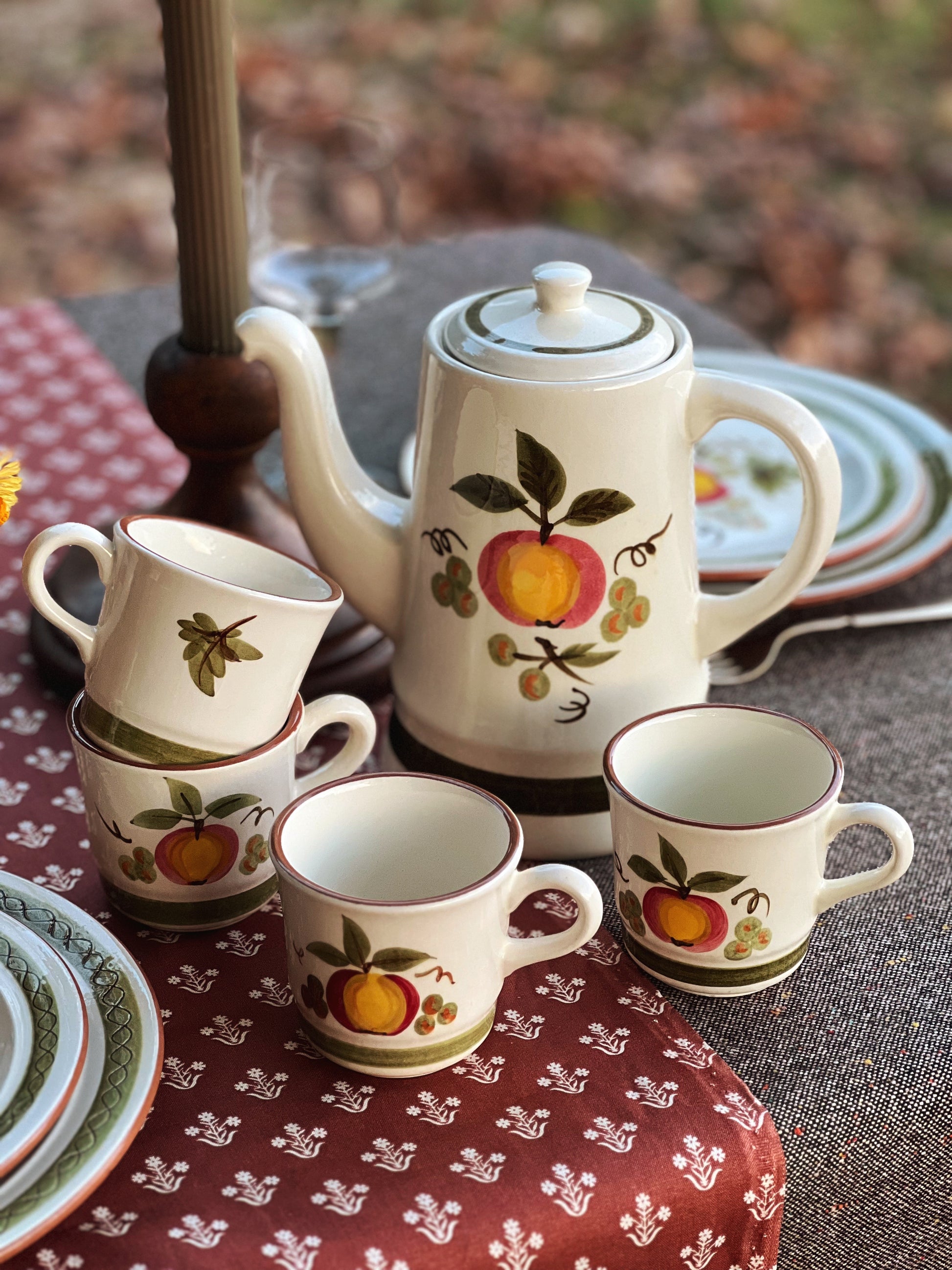 coffee pot and cups on a table outside in fall