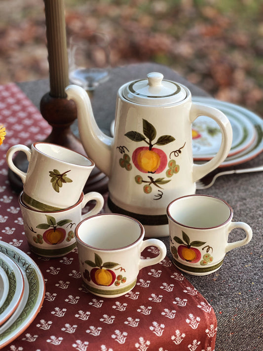 coffee pot and cups on a table outside in fall