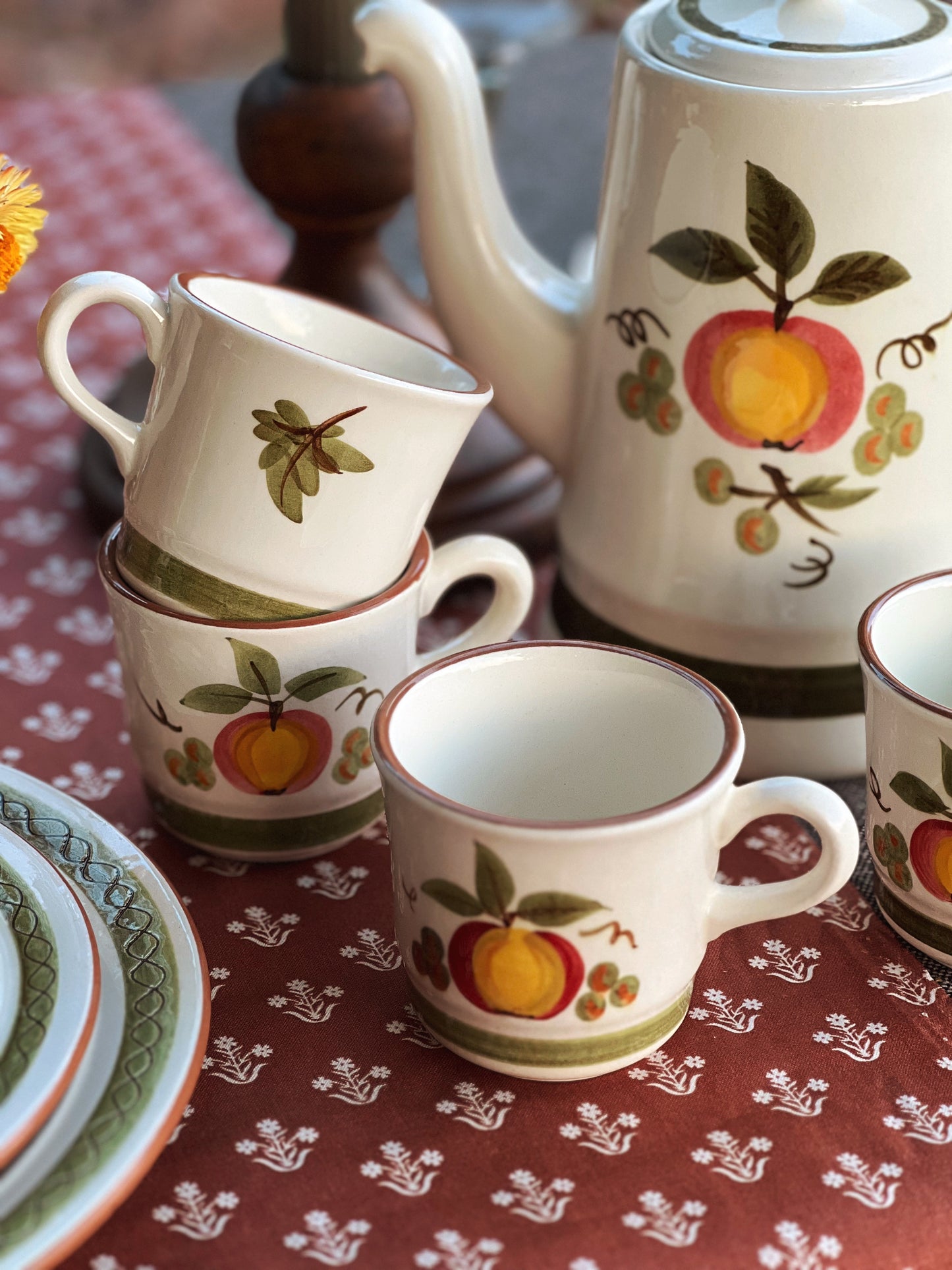 vintage hand painted teacups on a table outside in fall