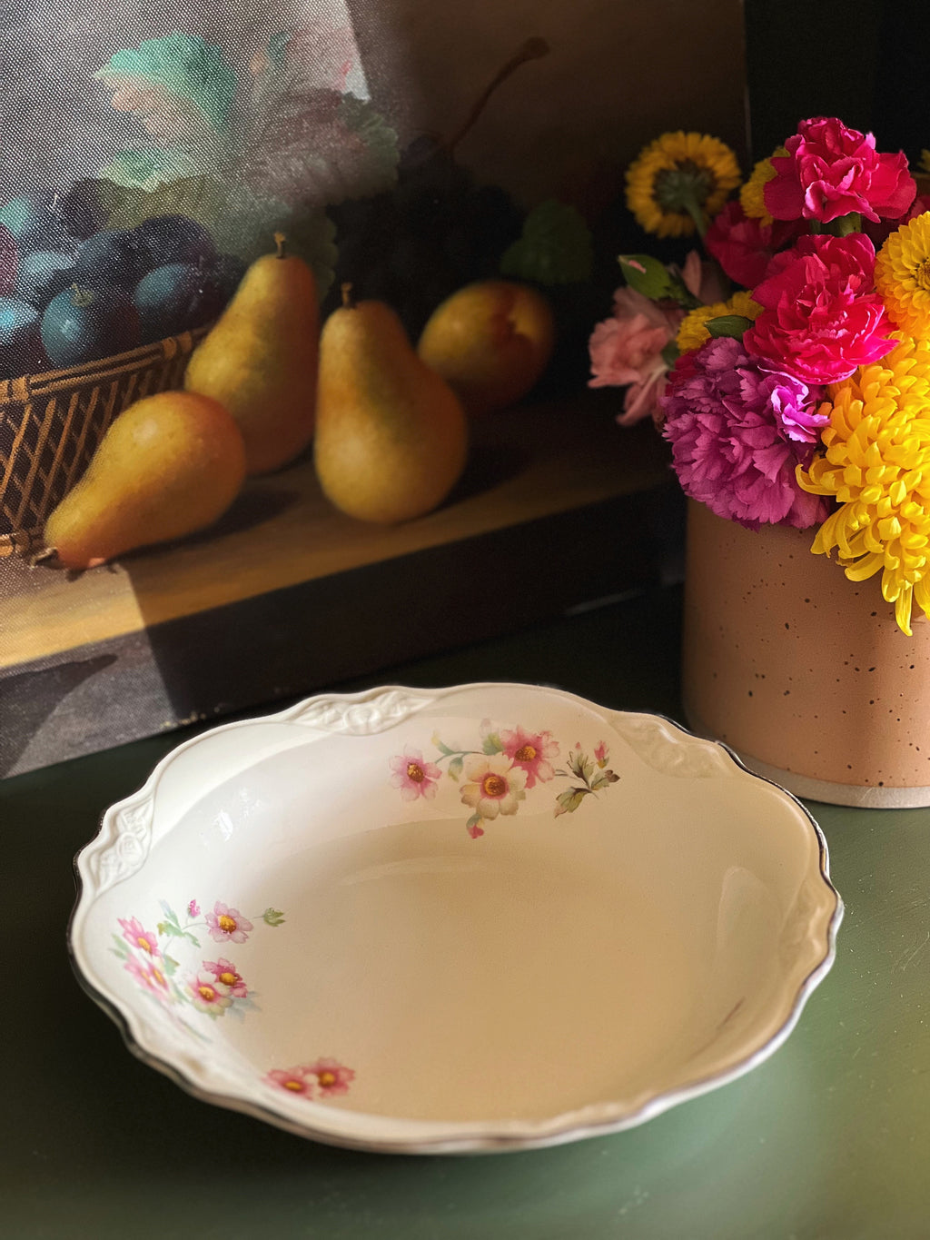 Vintage Homer Laughlin Virginia Rose coupe soup bowl styled with fruit and flowers on green surface
