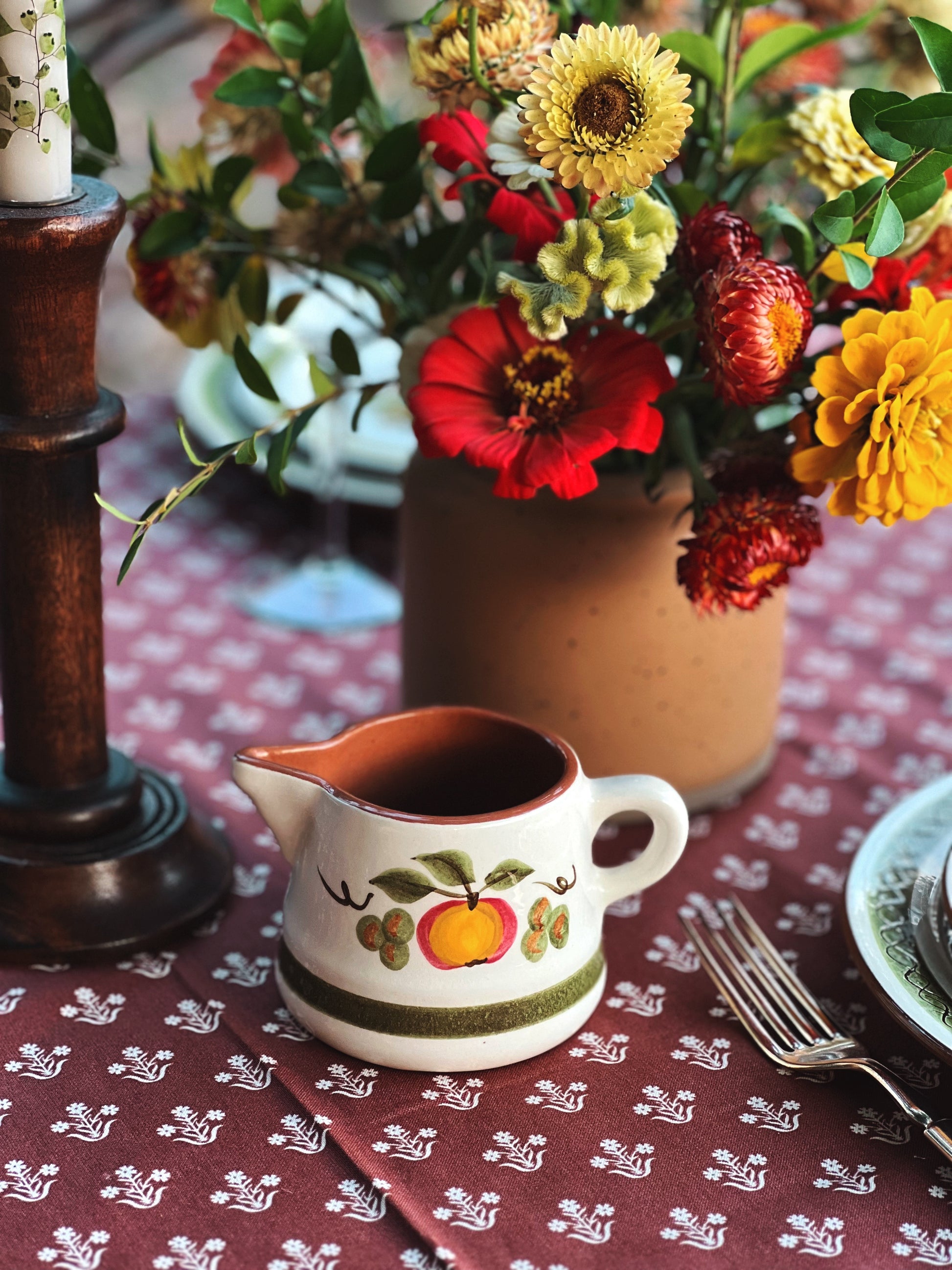 vintage creamer on a table outside in fall