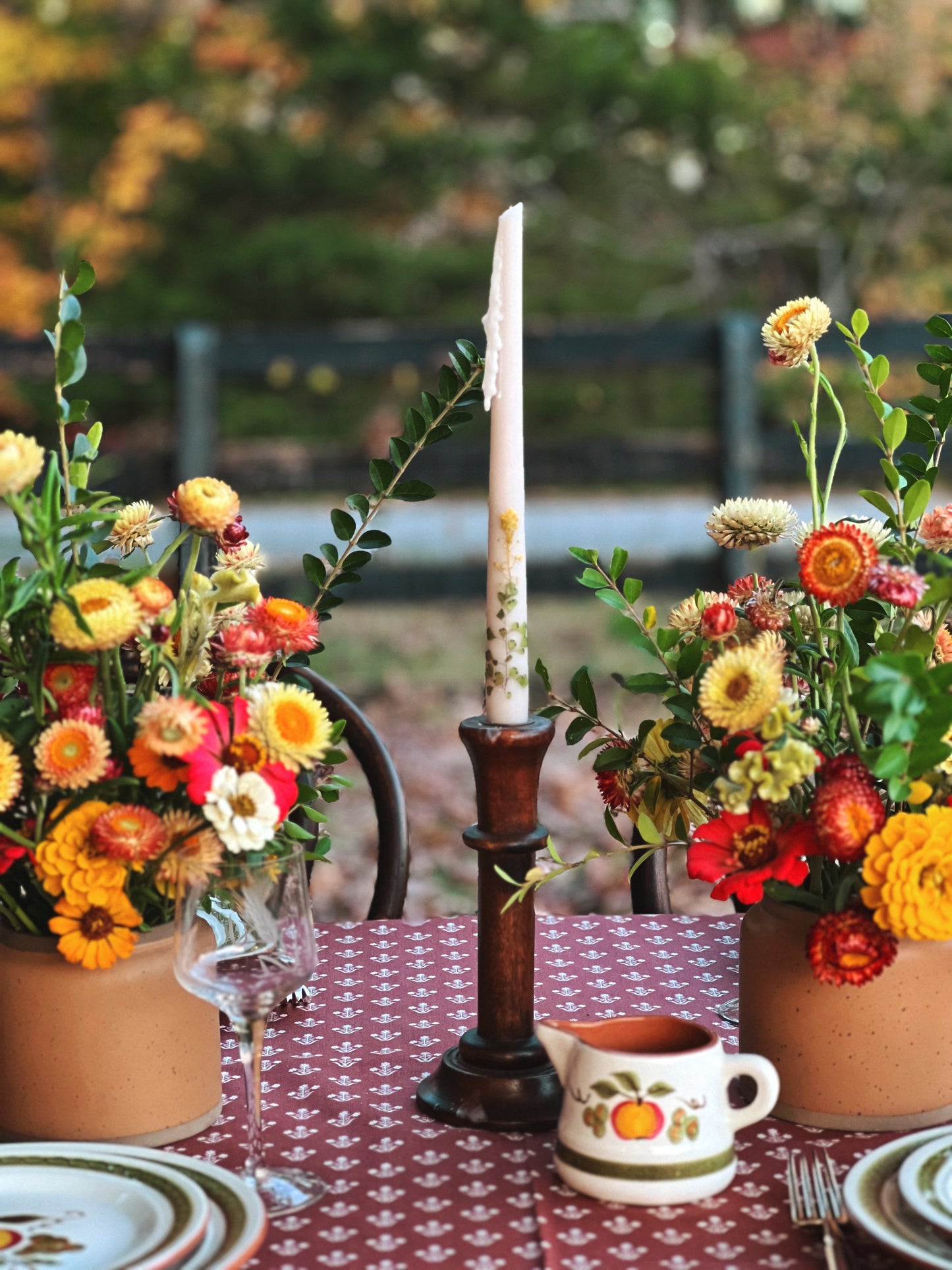 wood candleholder on a table outside in autumn