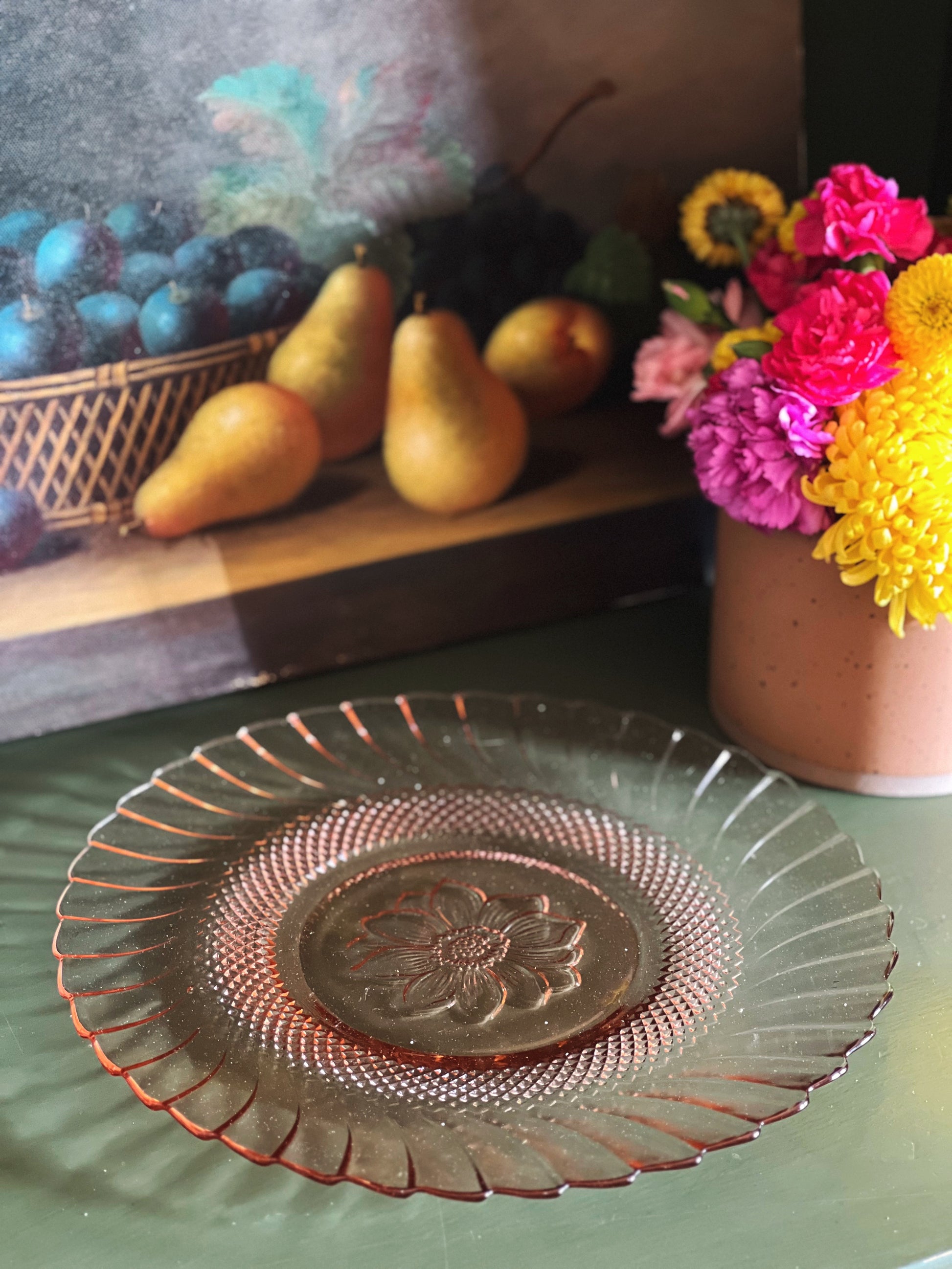 pink glass plate with a floral center