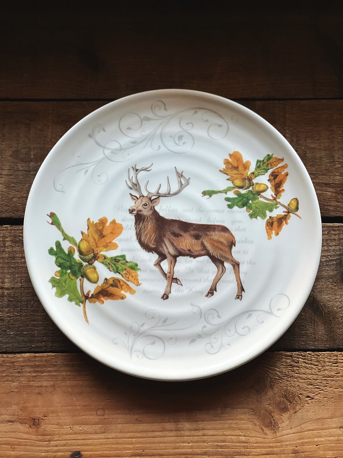 ceramic plate with a stag and acrorns and leaves