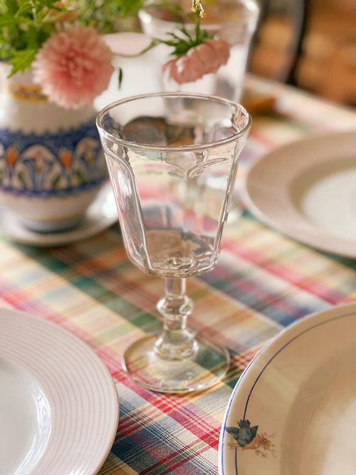 wine glass on a table set for dinner