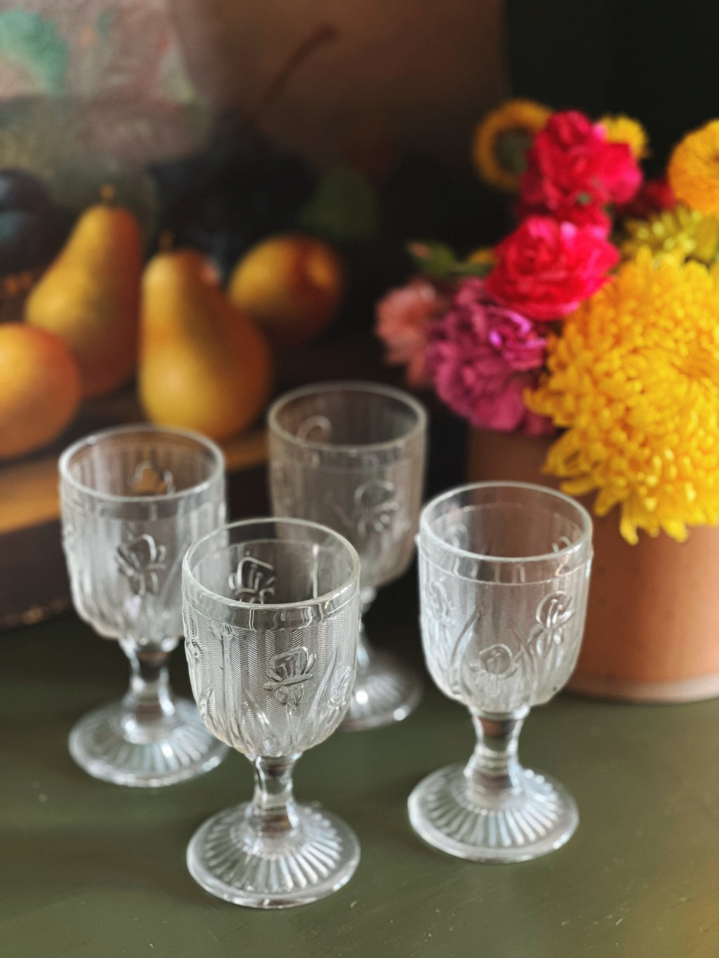 four small wine glasses with a frosted floral design