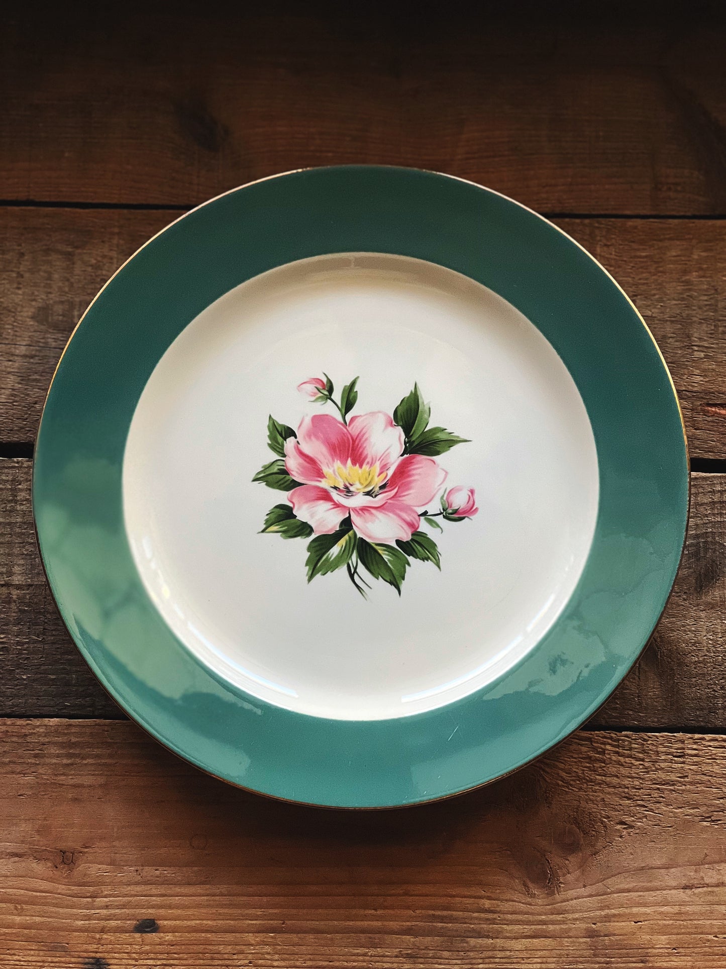 green rim dinner plate with a pink floral center