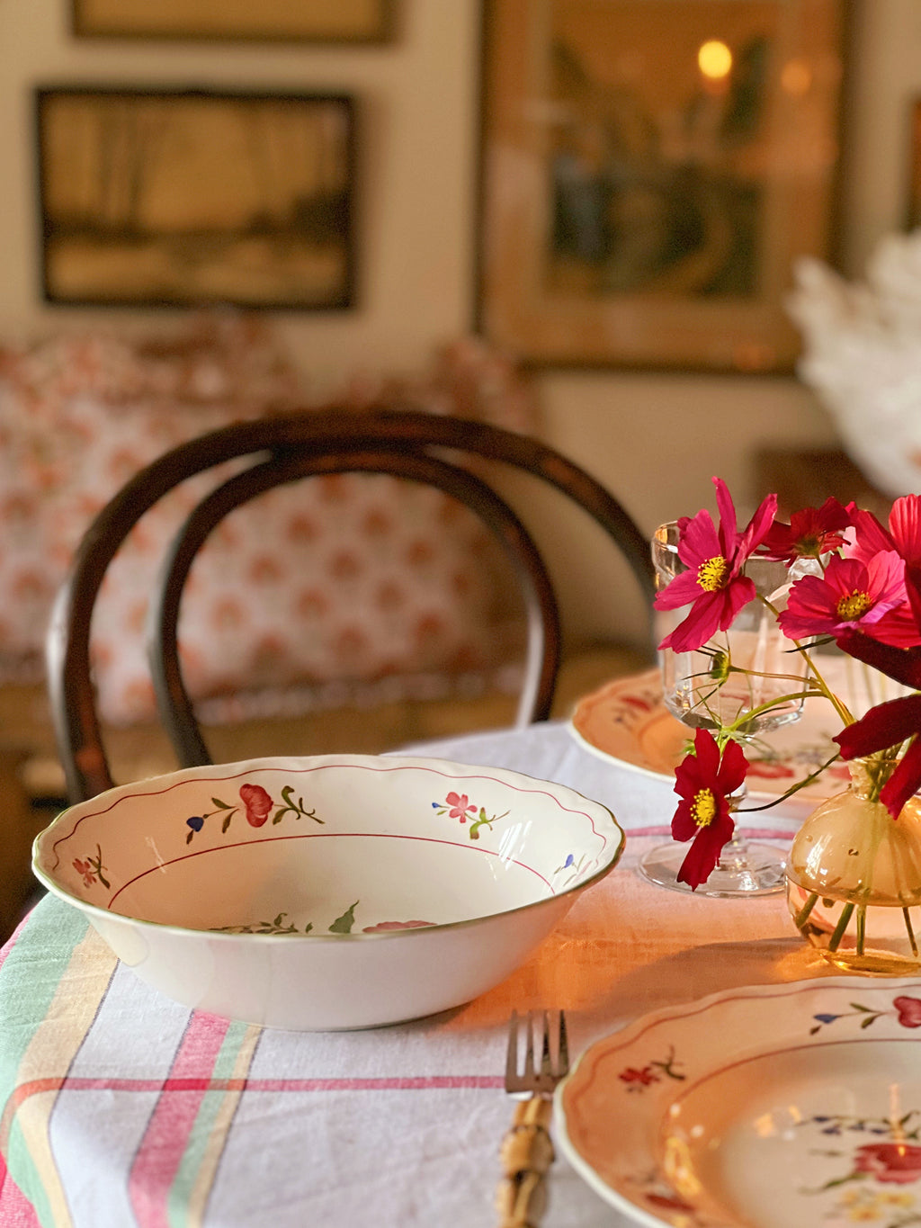 round vegetable bowl on a table set for dinner