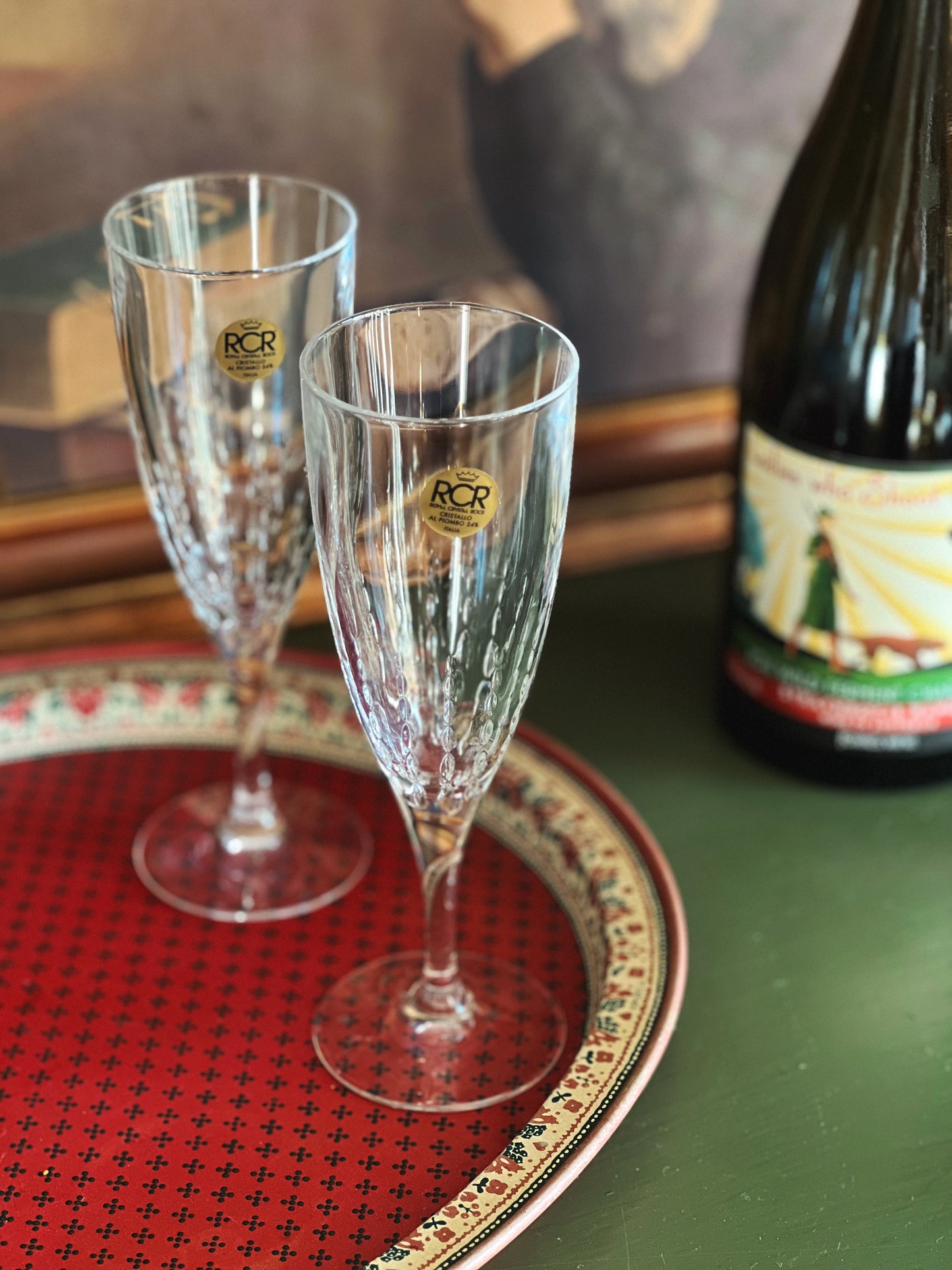 pair of crystal champagne flutes on a serving tray