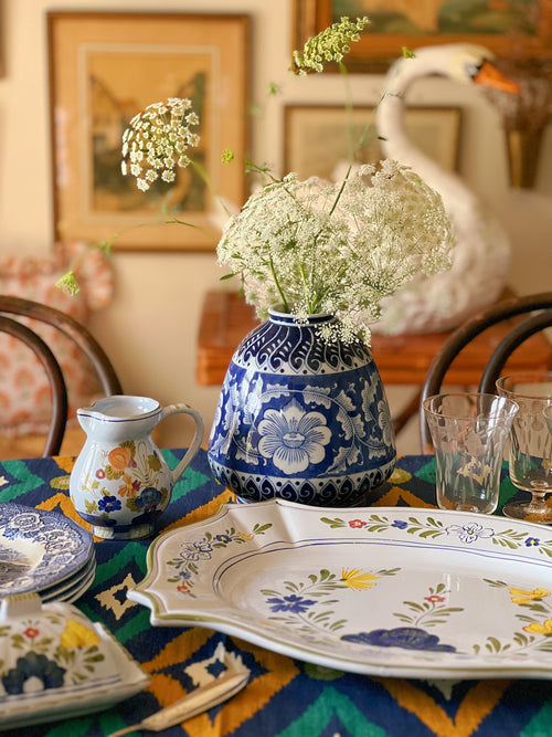 blue and white floral vase set on a table
