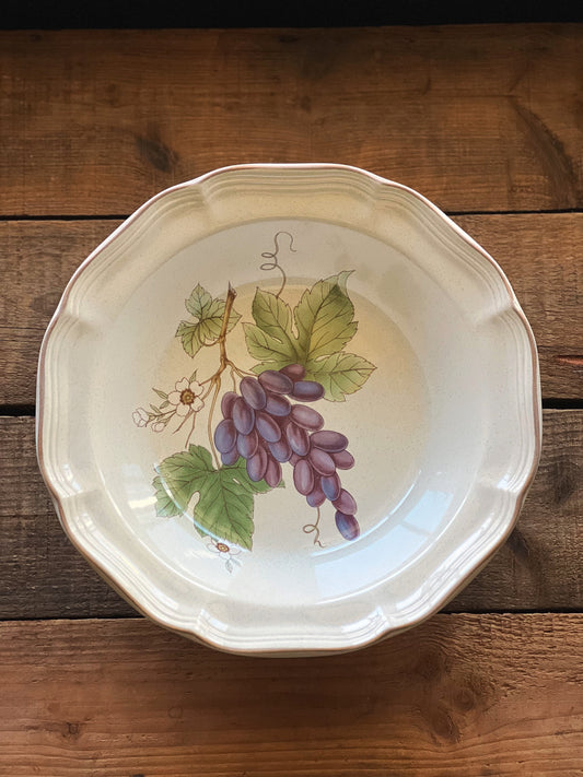 round vegetable bowl with a grape cluster design