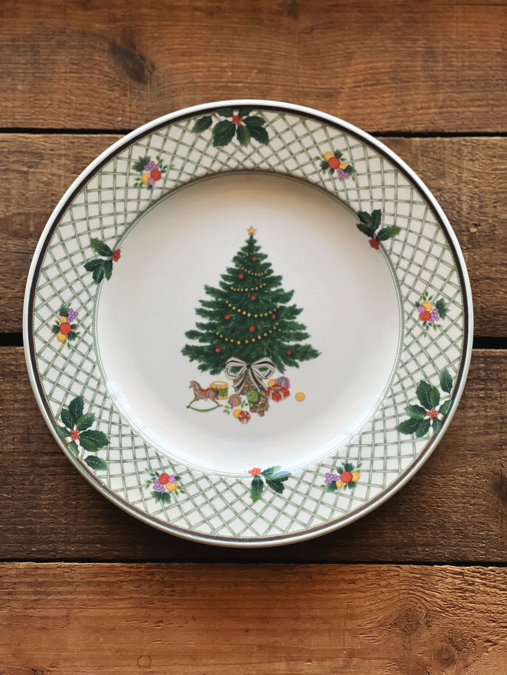 Decorative plate with Christmas tree design on a wooden surface