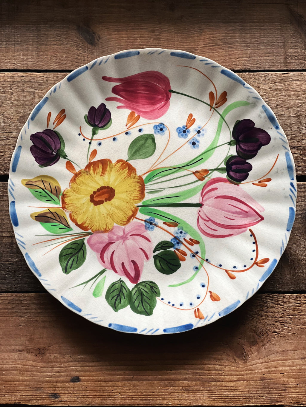 Decorative plate with floral design on a wooden surface