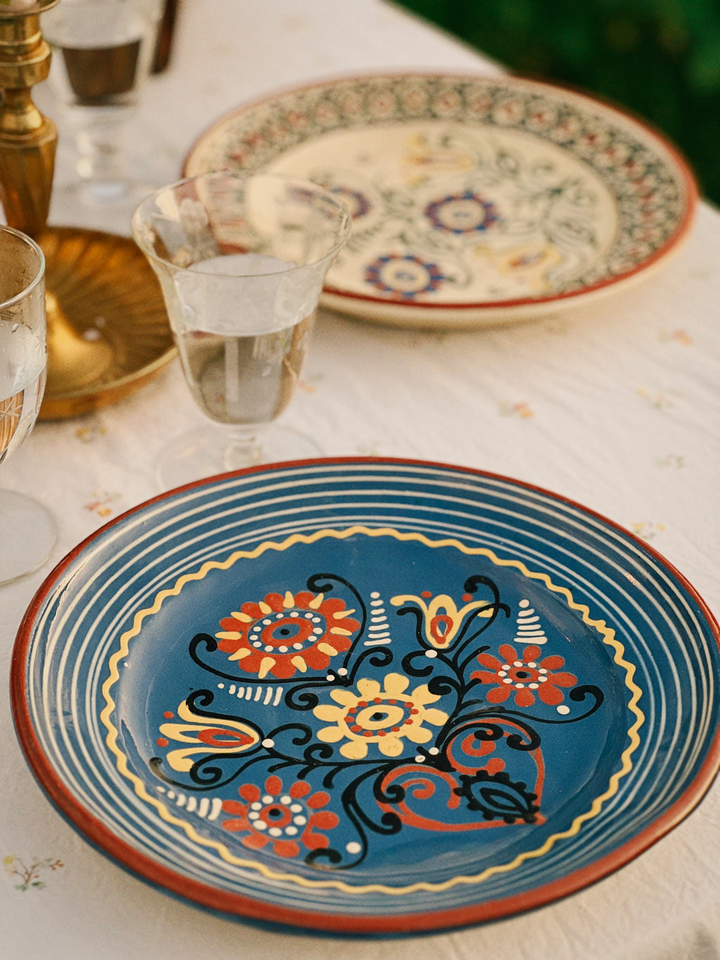Decorative ceramic plates with floral patterns on a table.