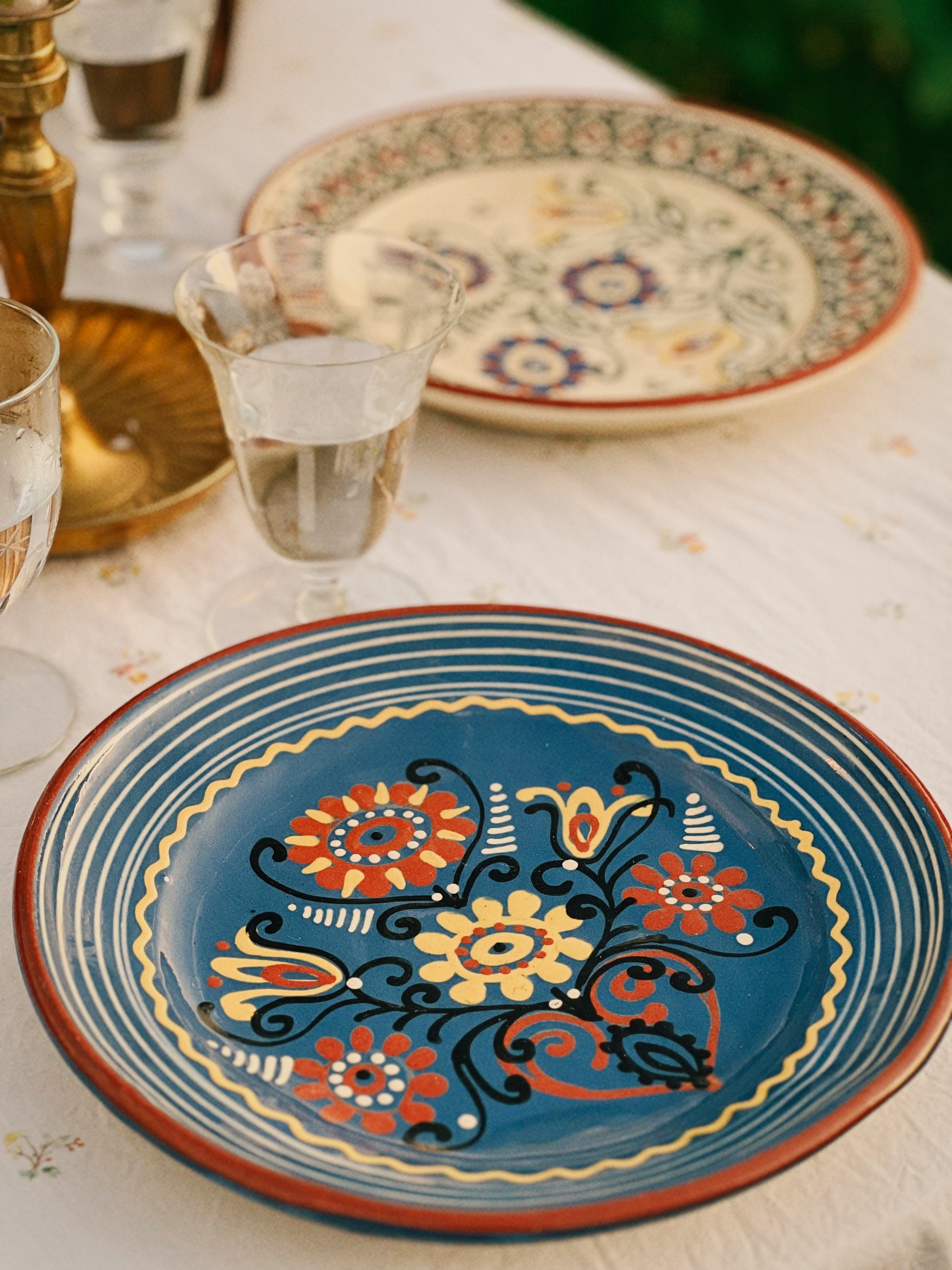 Decorative ceramic plates with floral patterns on a table.