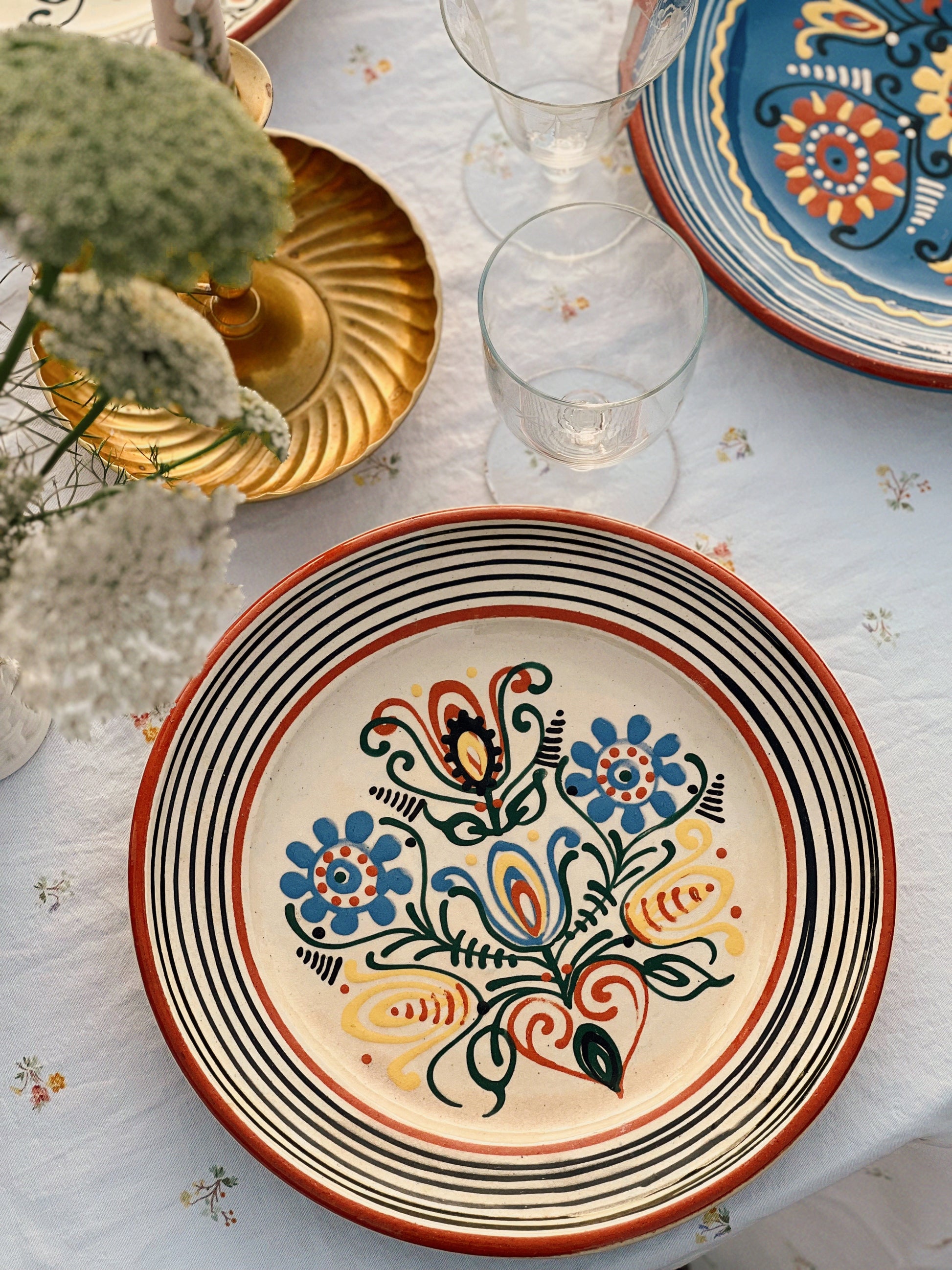 Decorative ceramic plate with floral design on a table setting.