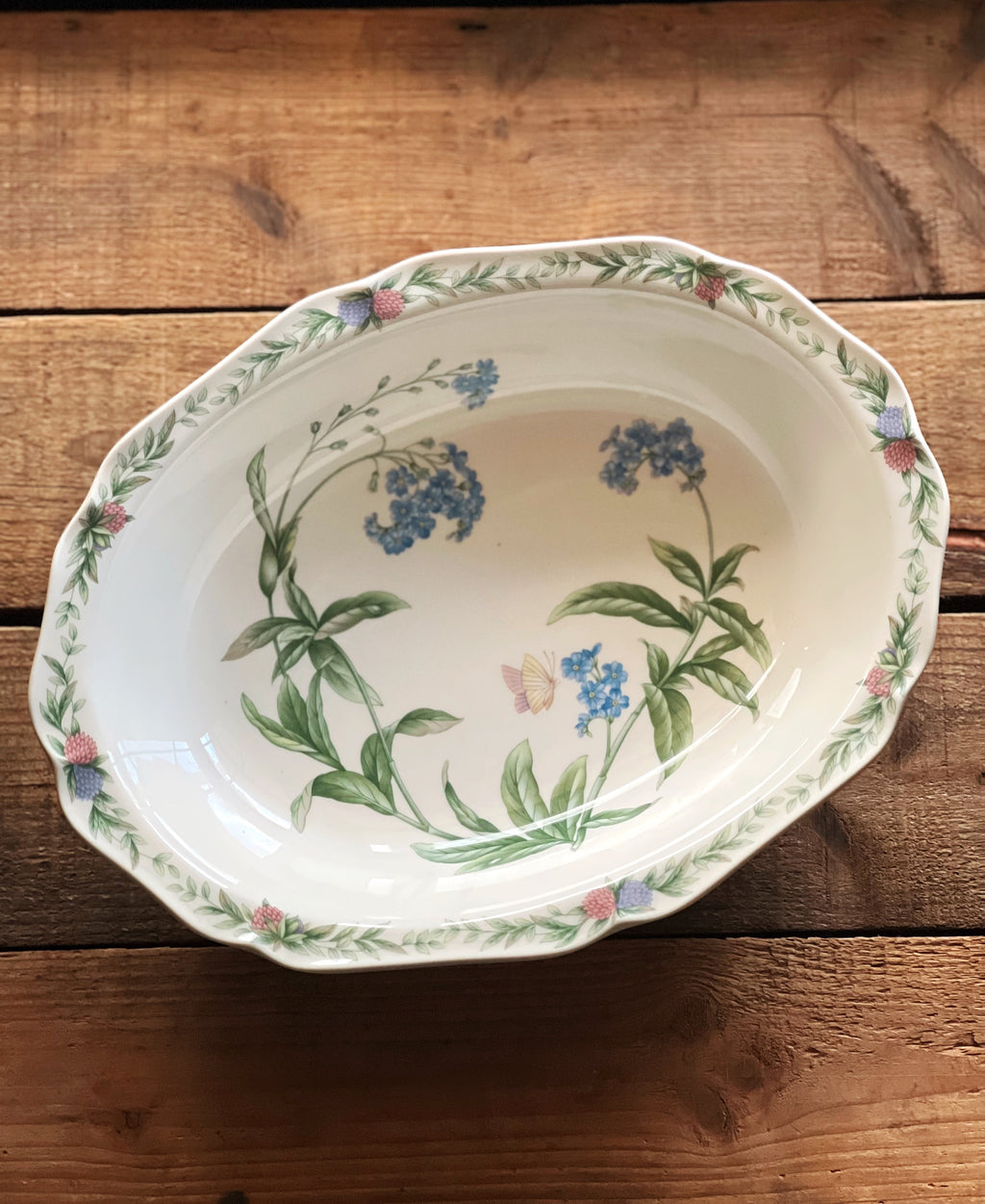 multicolor floral vegetable bowl on a wooden surface