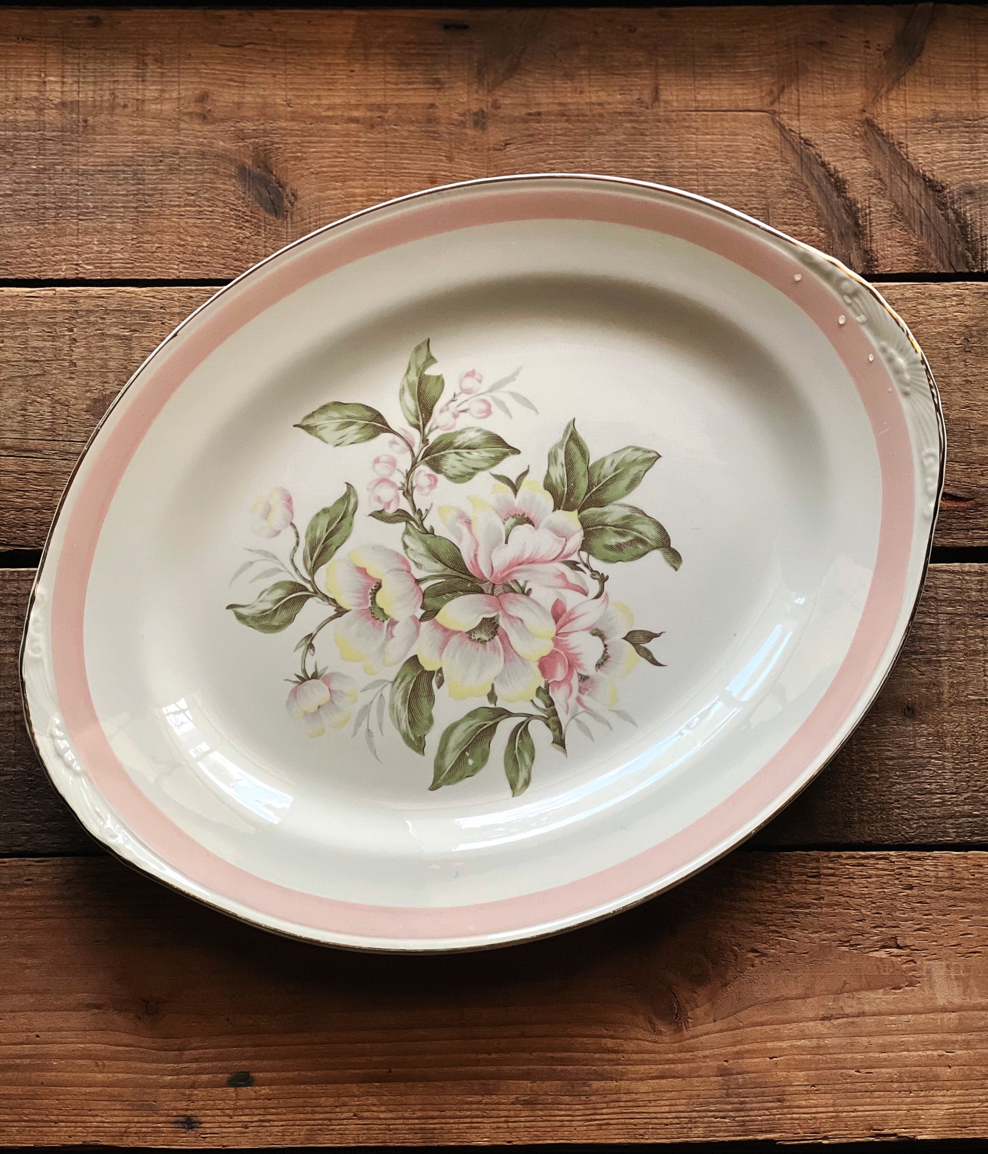 Floral-patterned ceramic platter on a wooden surface
