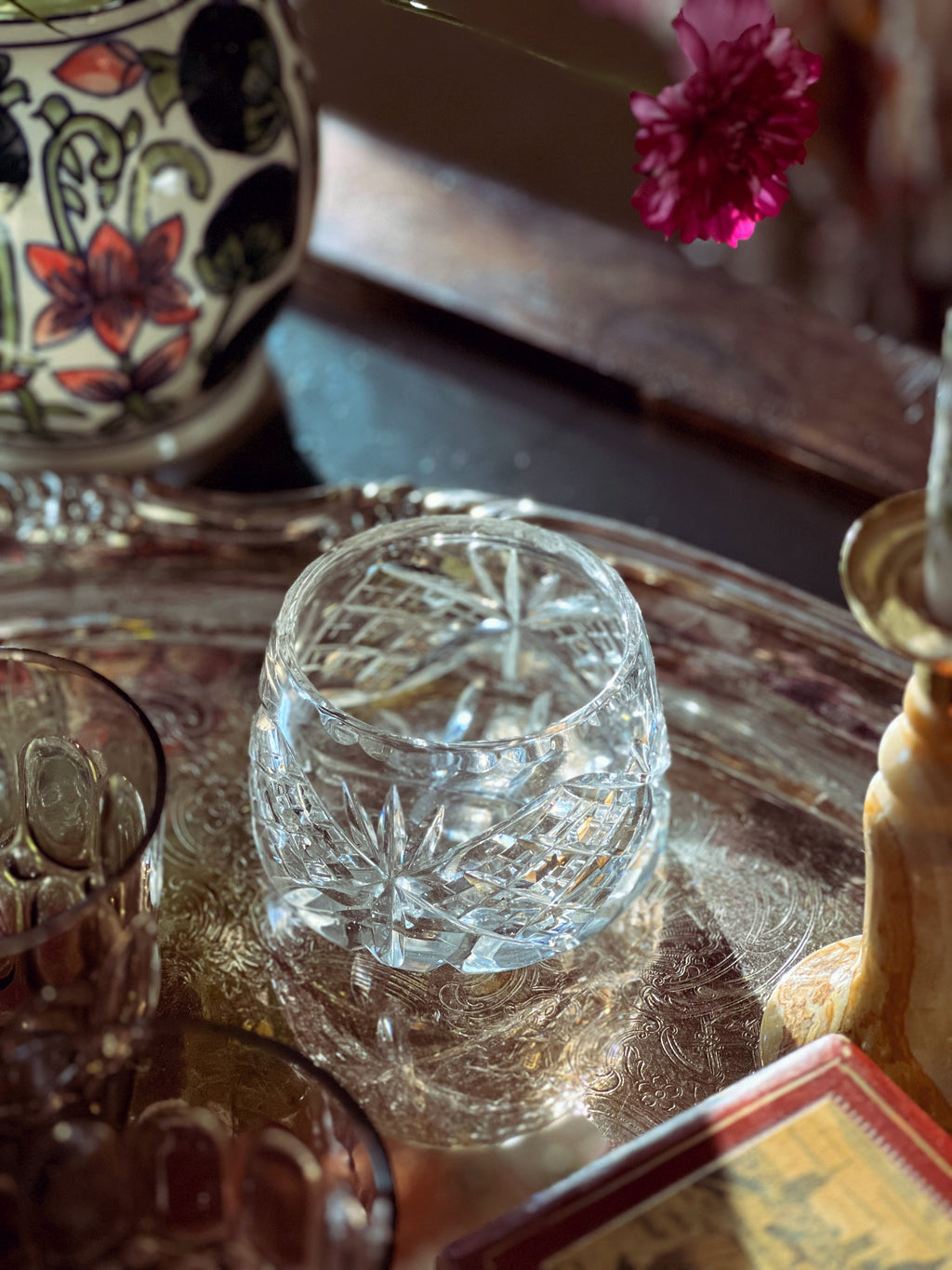Crystal glass on a reflective surface with a blurred background