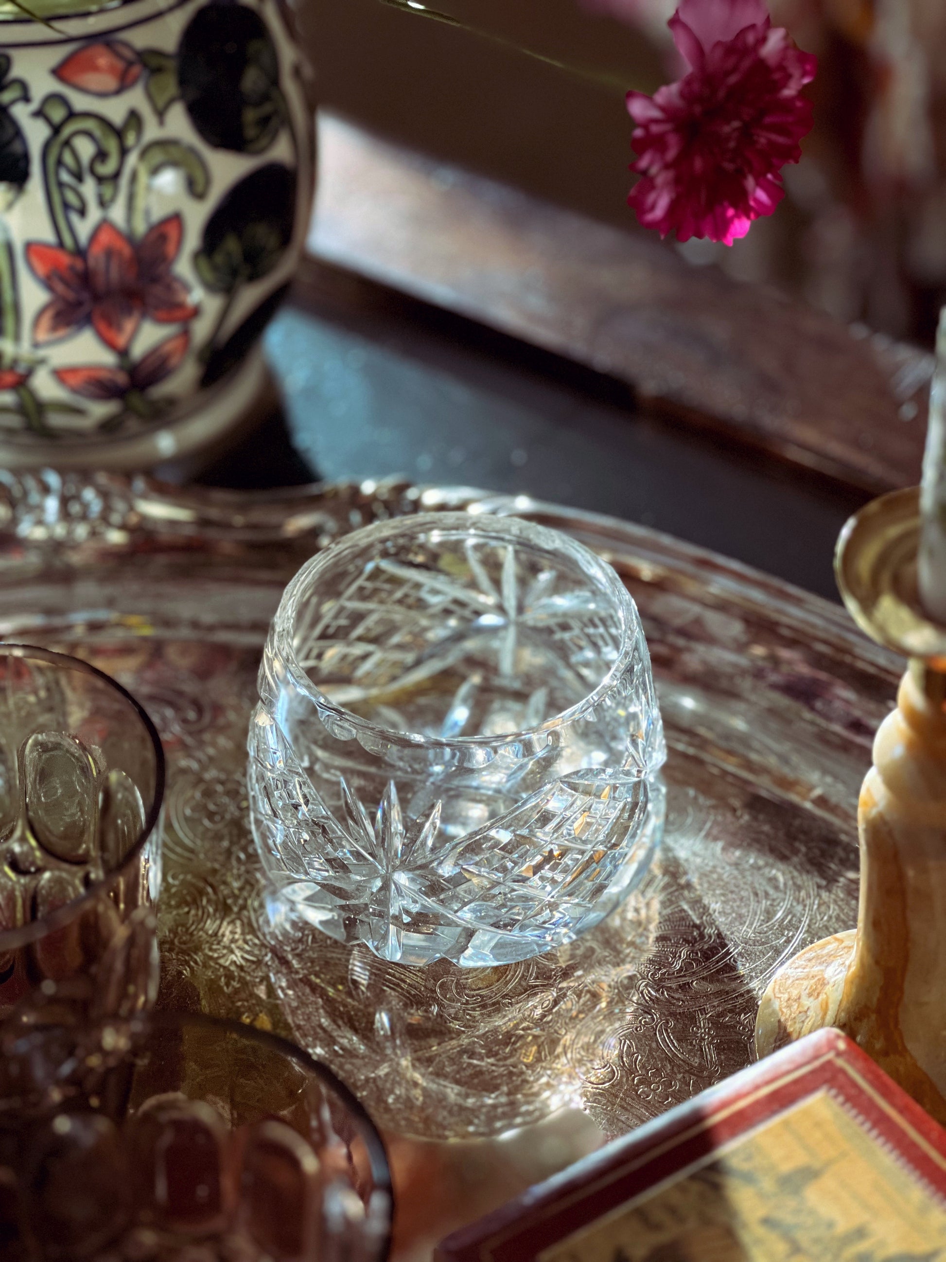 Crystal glass on a reflective surface with a blurred background