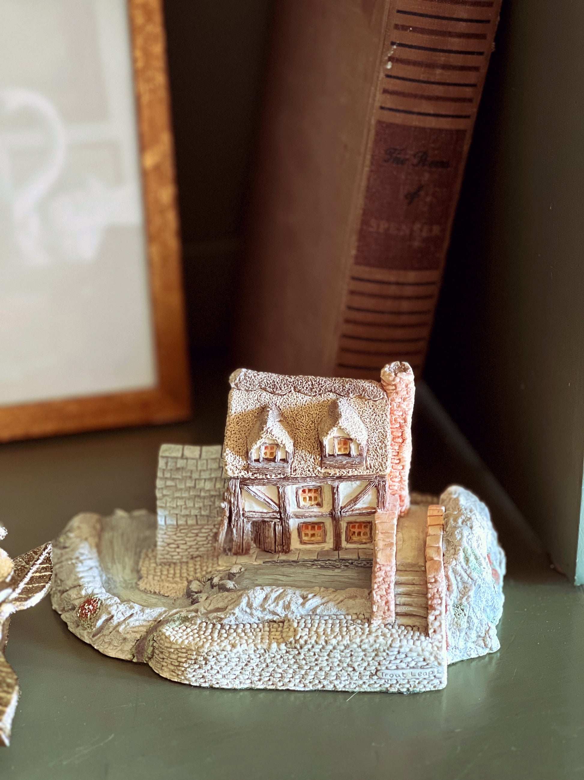 Miniature model of a house with decorative elements on a surface
