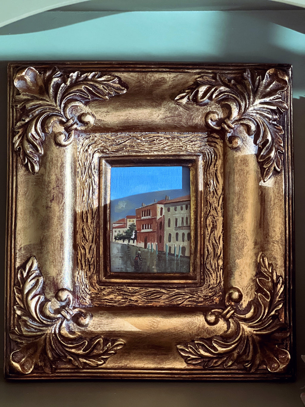 small oil painting in a gold gilt frame