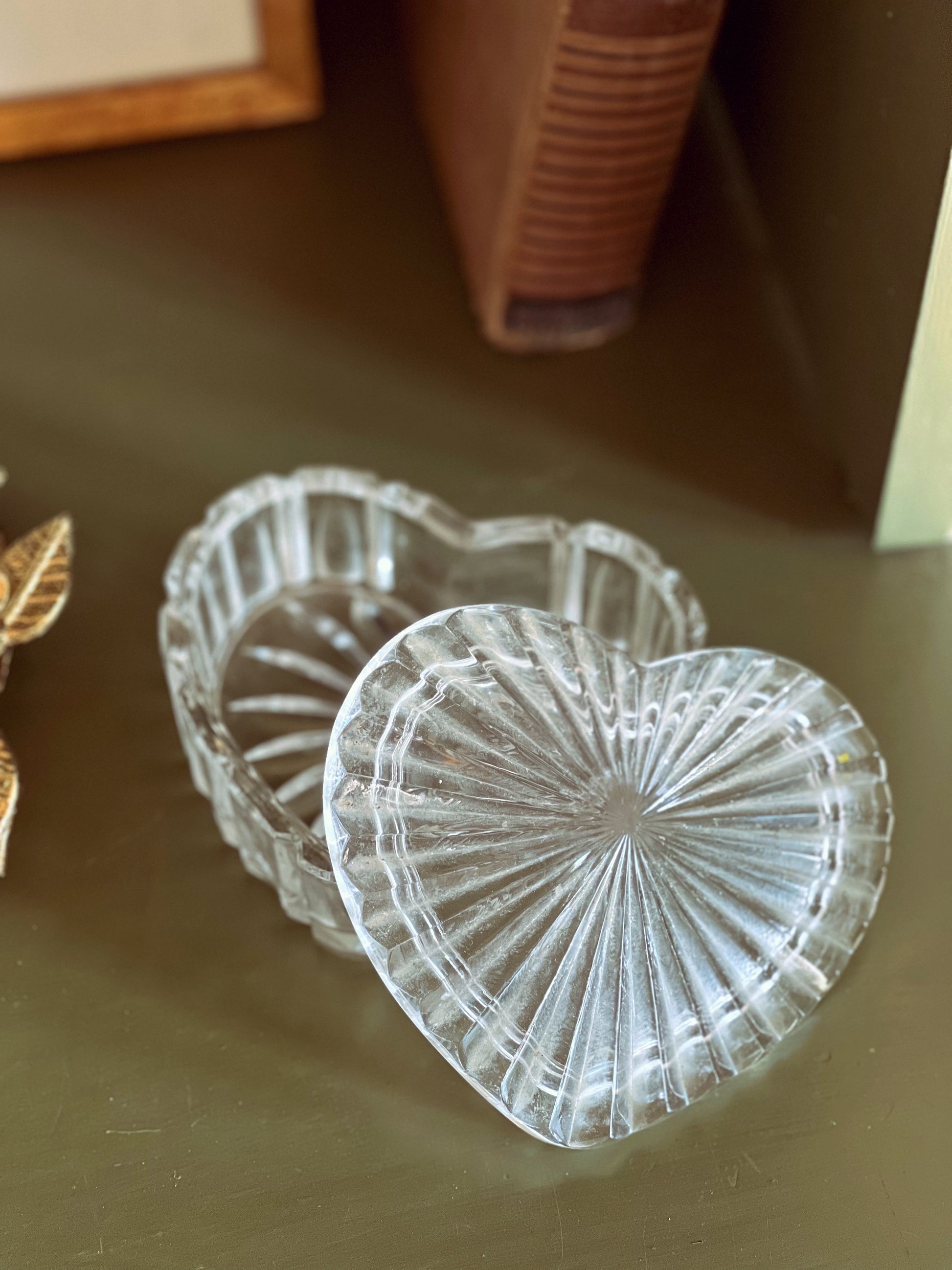 Clear glass heart-shaped bowls on a wooden surface