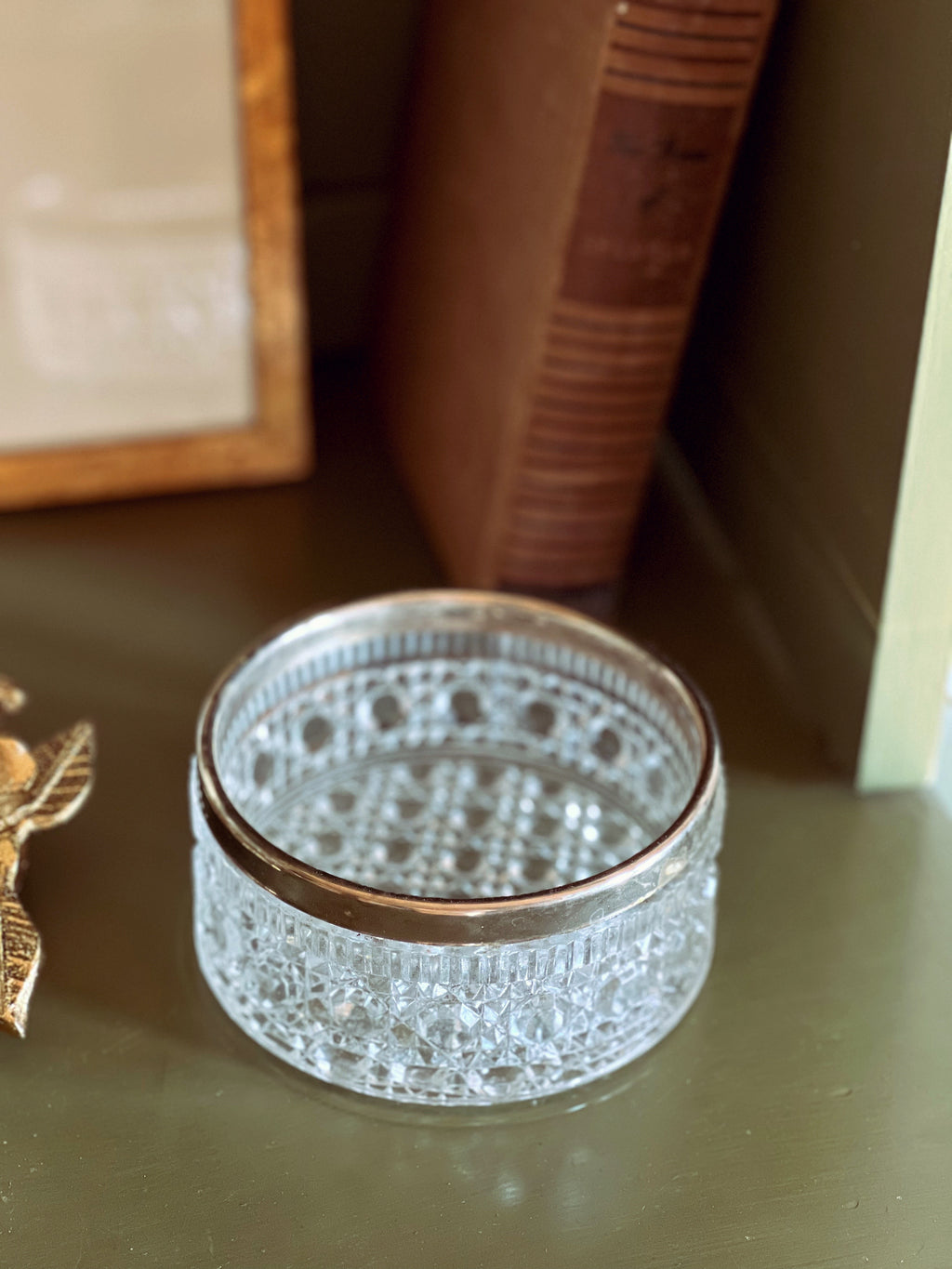 Decorative glass box with intricate patterns on a wooden surface