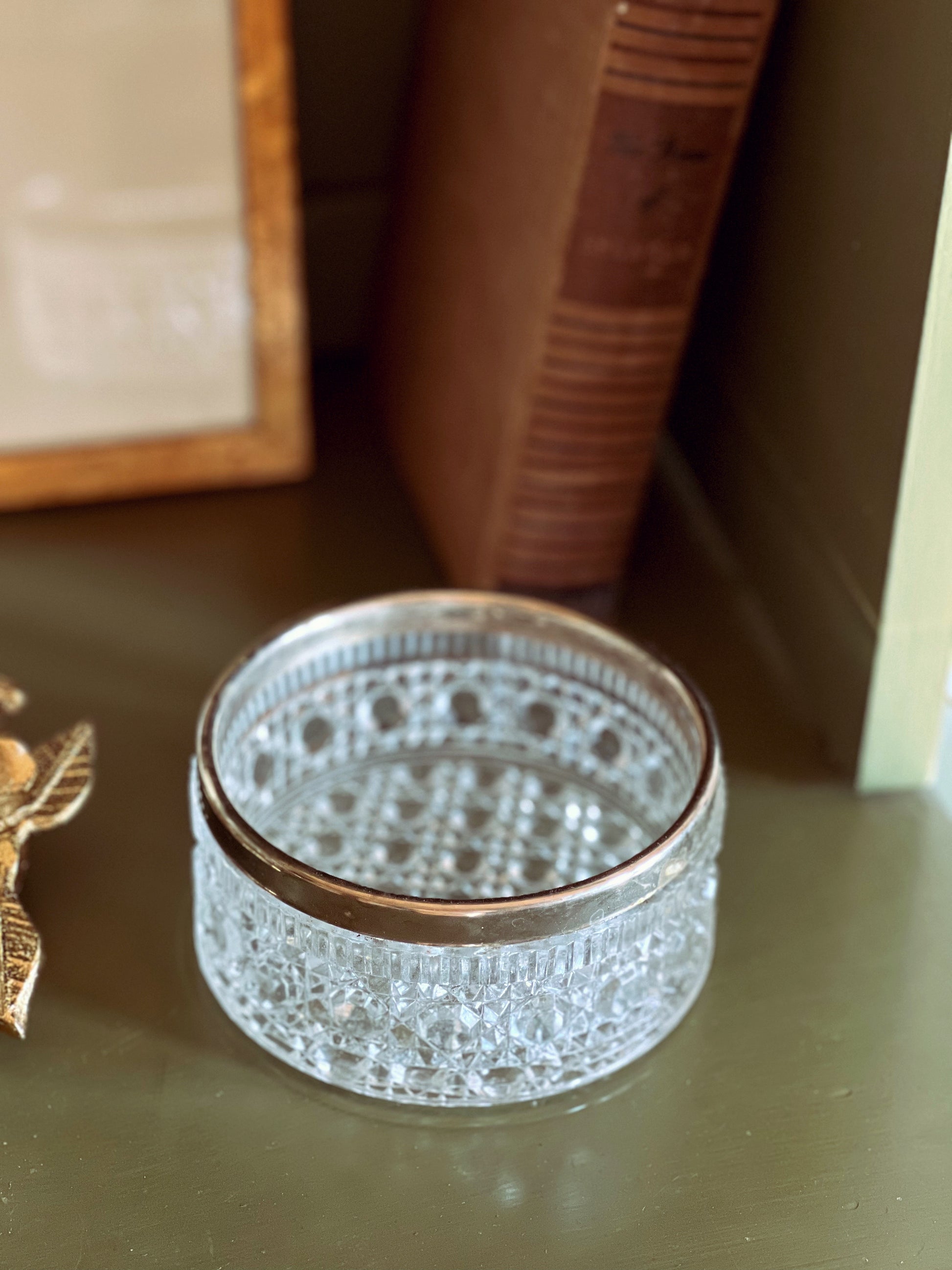 Decorative glass box with intricate patterns on a wooden surface