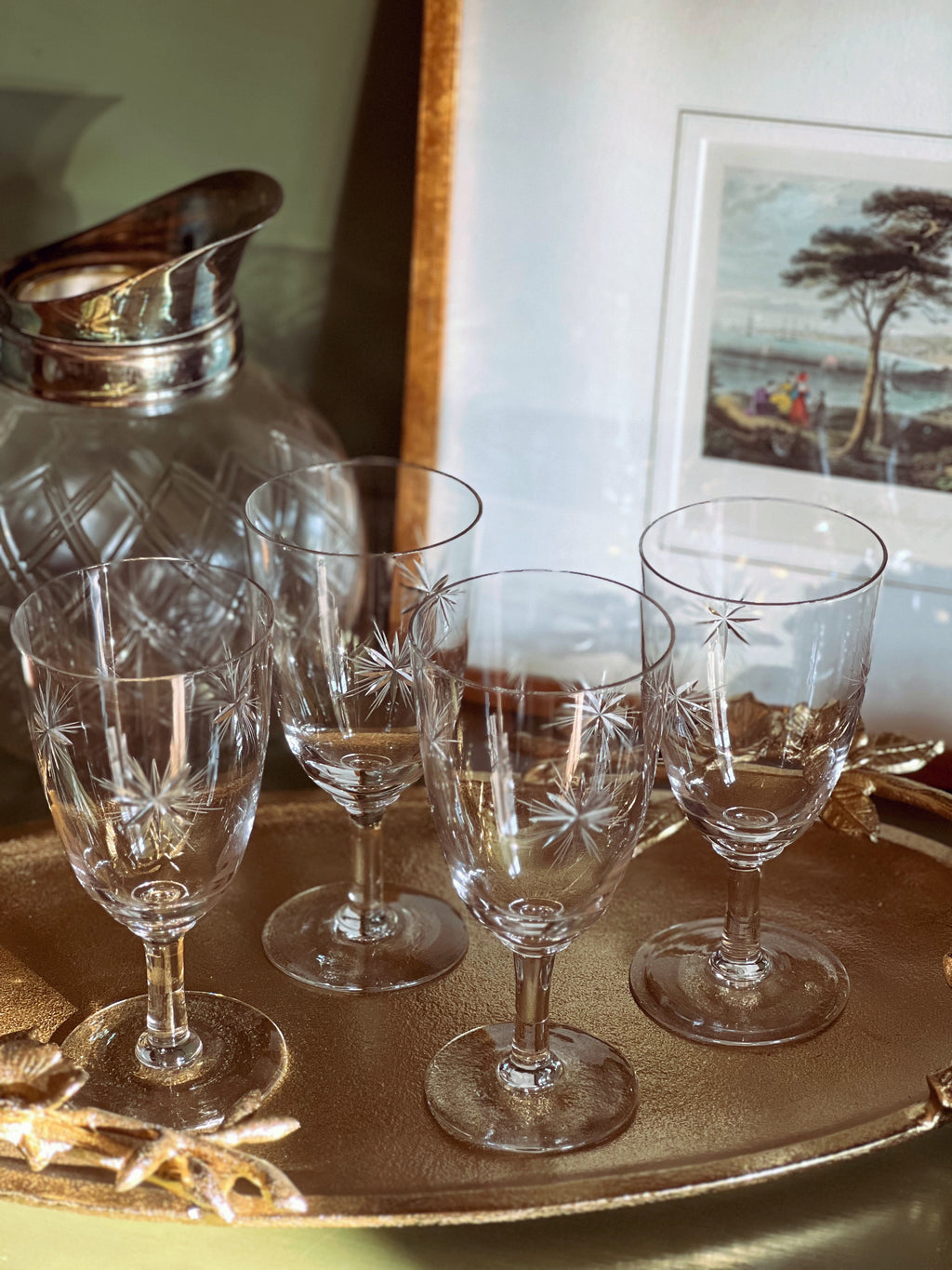 Set of crystal glasses on a tray with a decorative background