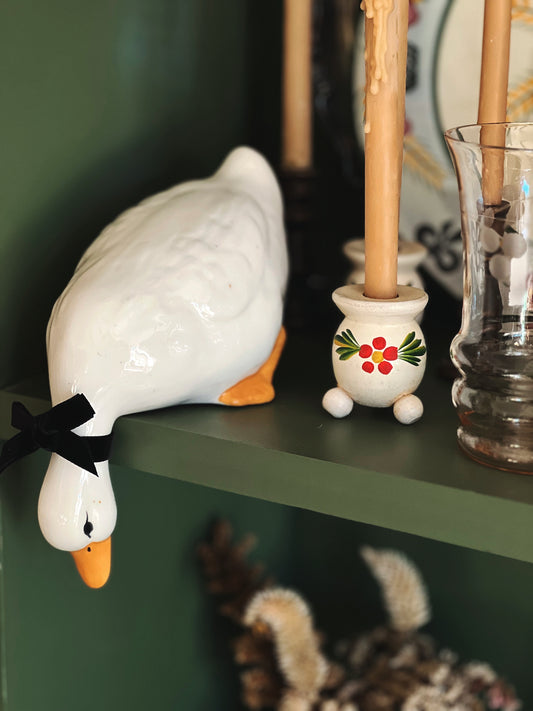 leaning duck figurine