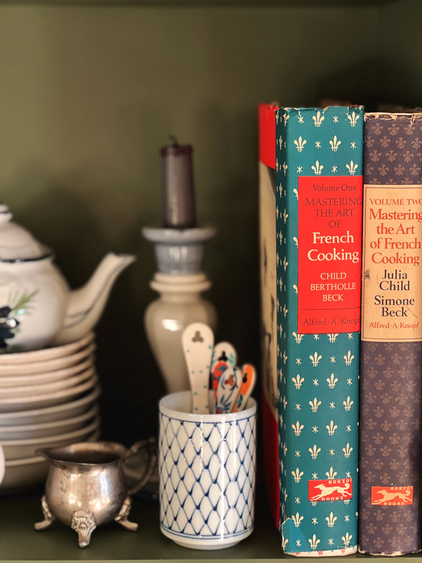 Julia Child's cookbooks on a shelf