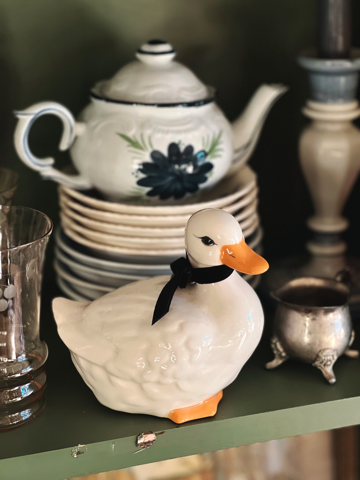 small duck figurine on a shelf