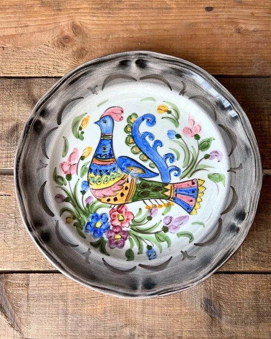 hand painted wall plate with a bird design 