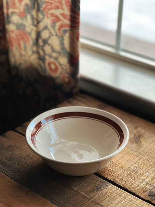 stoneware serving bowl with a brown banded rim