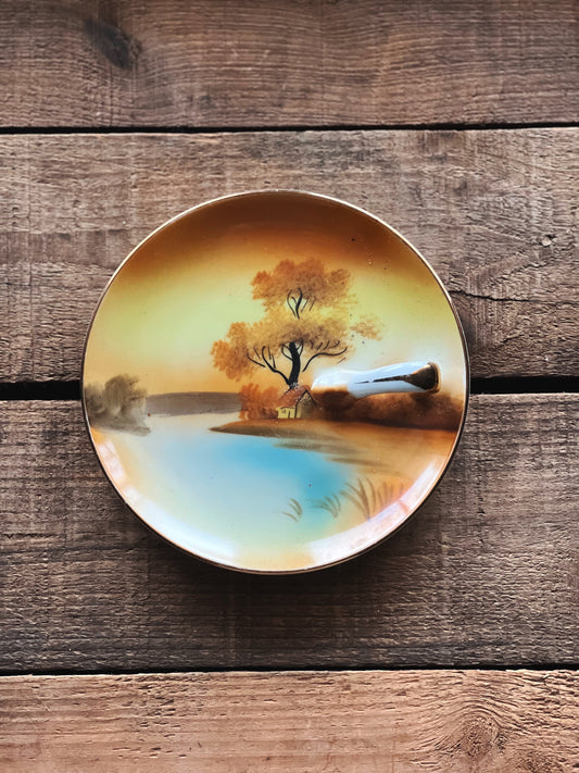 small hand painted dish with landscape design