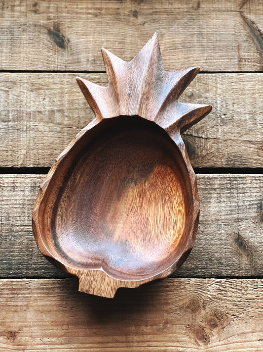 wooden bowl carved into a pineapple