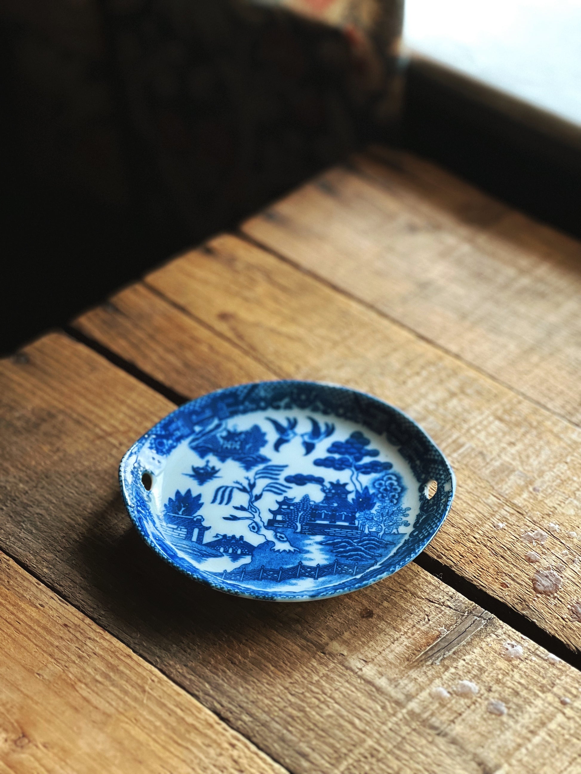 Blue and white ceramic dish on a wooden surface