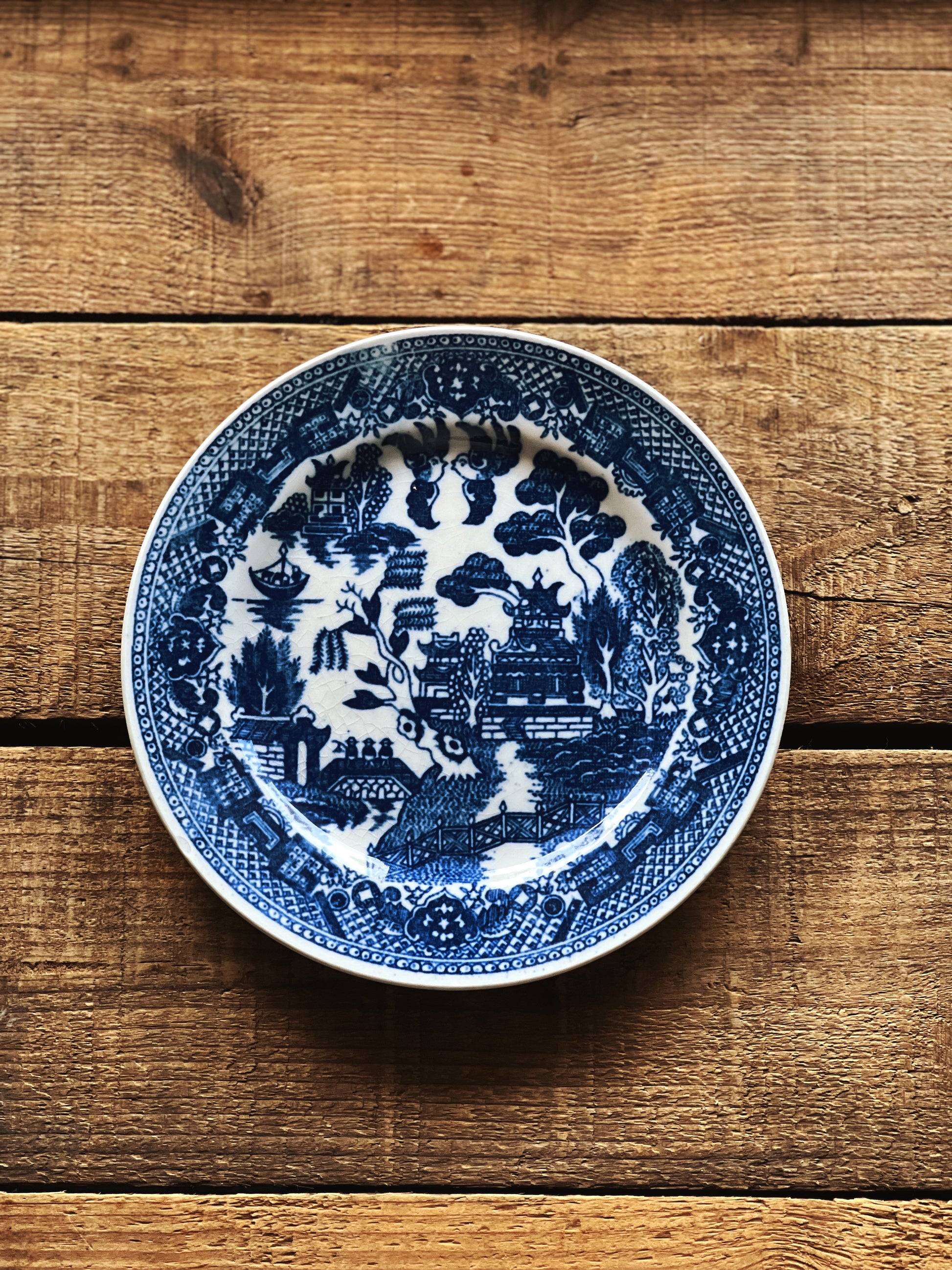 Blue and white decorative plate on a wooden surface