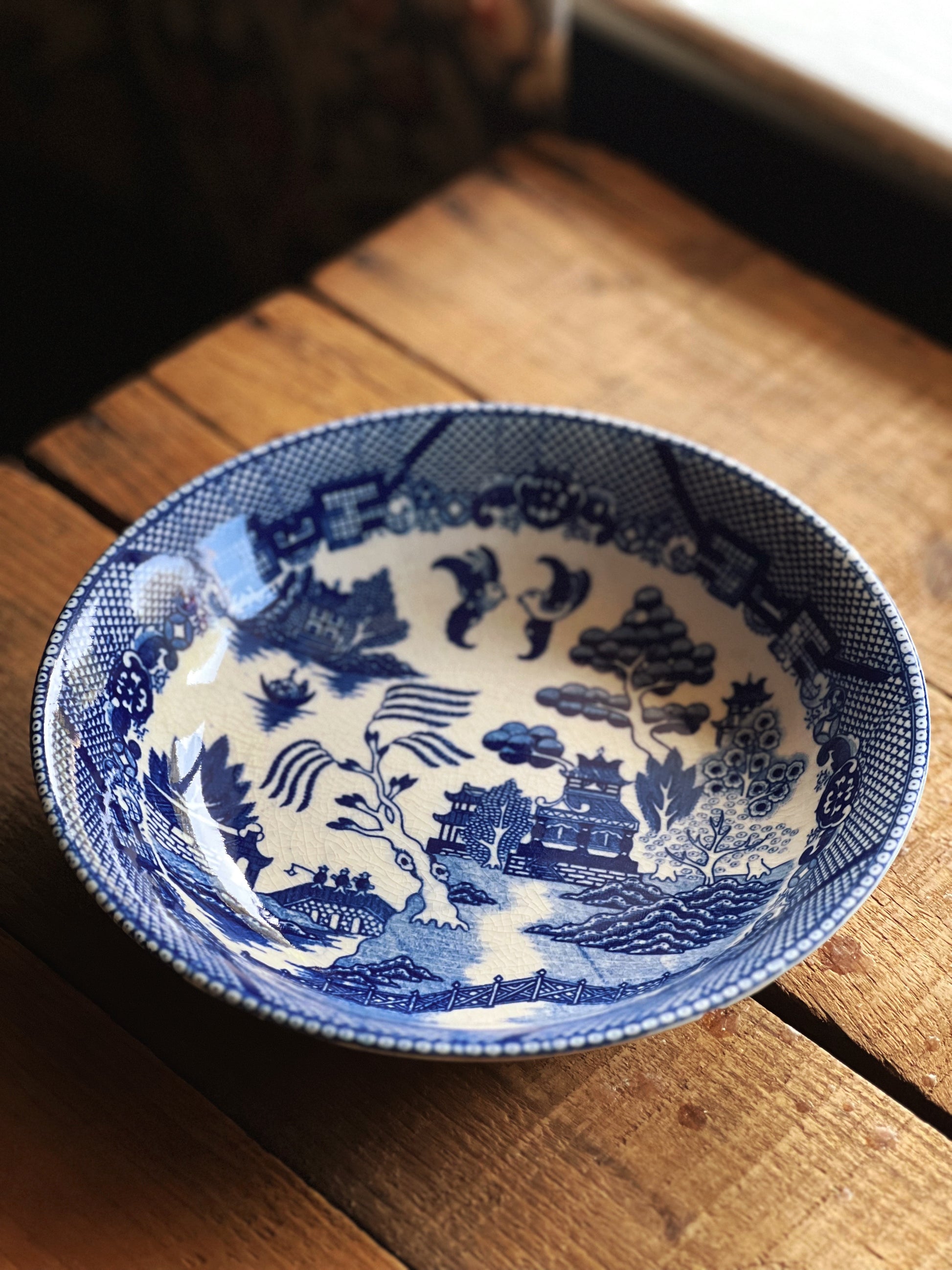 Blue and white ceramic bowl with intricate patterns on a wooden surface