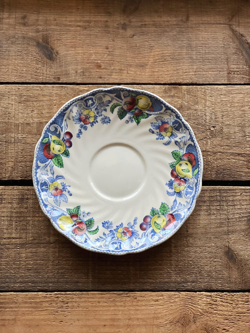 Decorative ceramic plate with floral patterns on a wooden surface