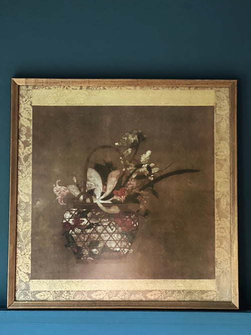 Framed artwork of a still life with flowers on a blue background
