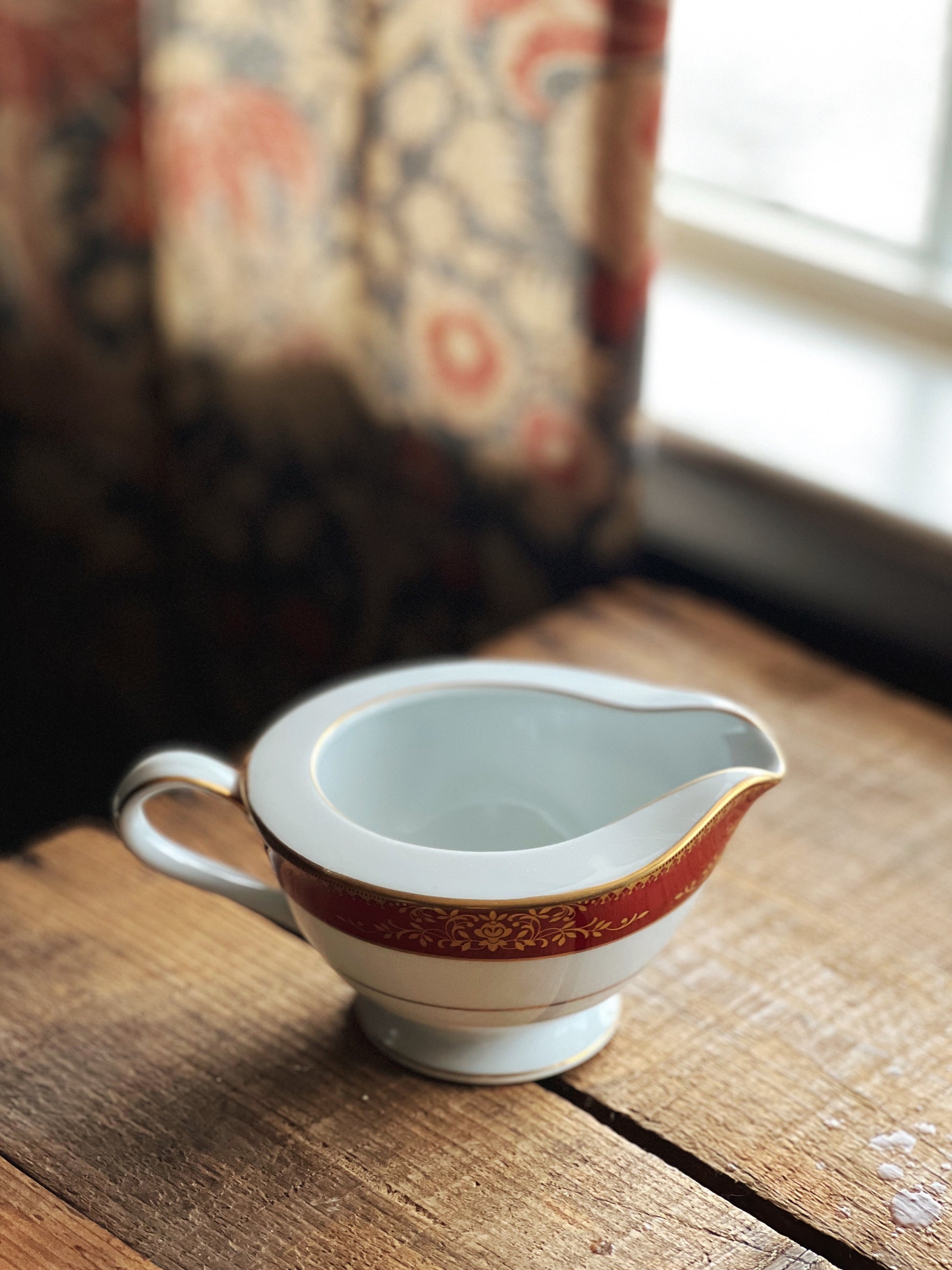 Noritake Goldmere creamer with red and gold banded design