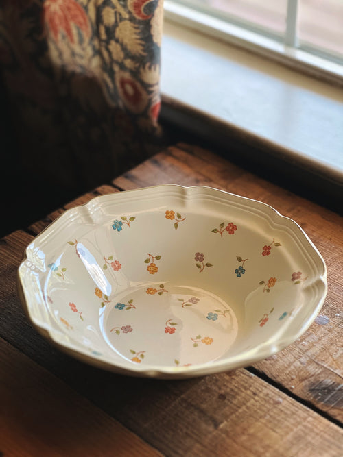 Decorative ceramic bowl with floral patterns on a wooden surface