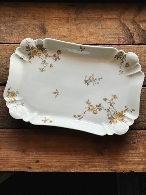 Decorative ceramic platter with floral patterns on a wooden surface