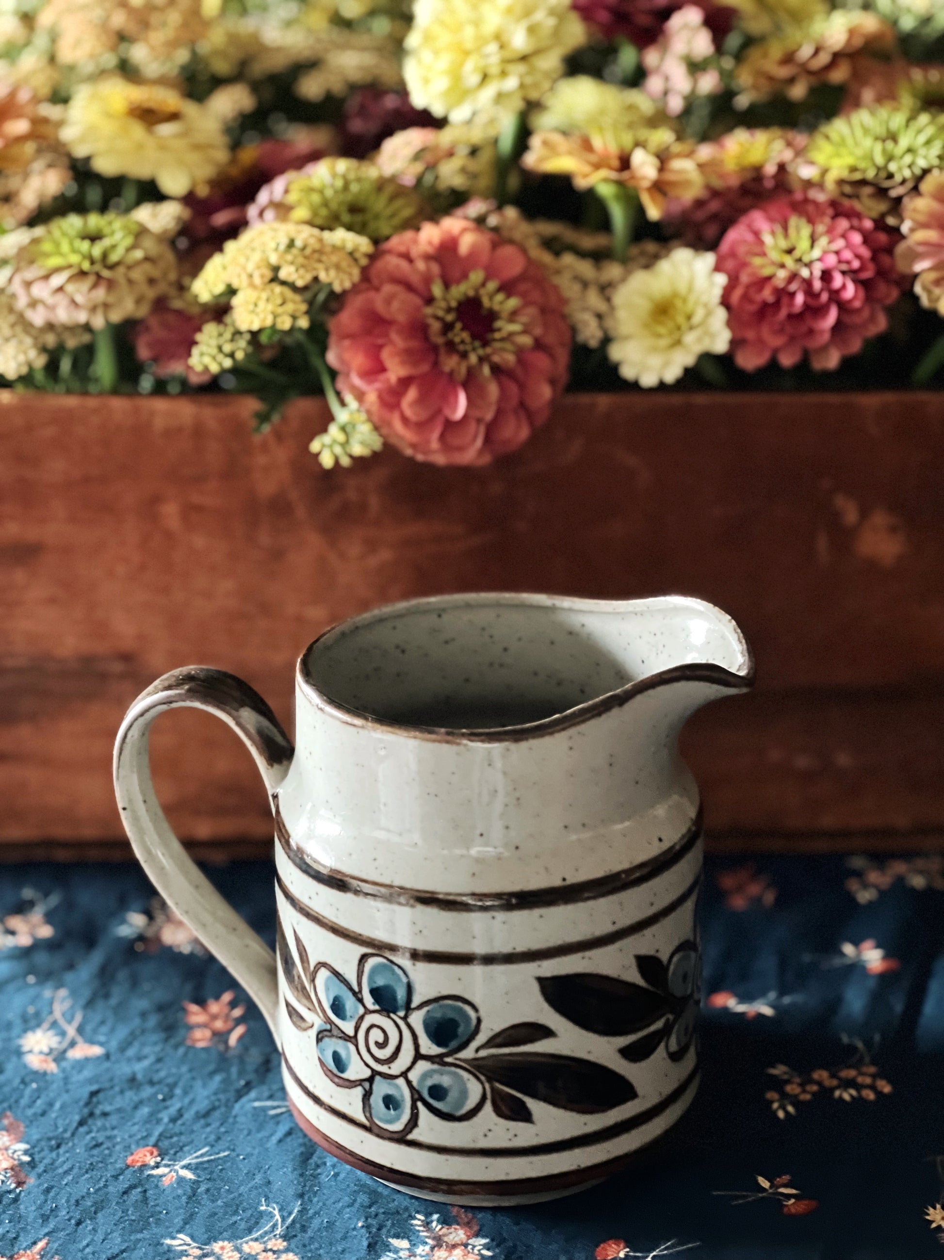 small gray and blue pitcher with brown accents
