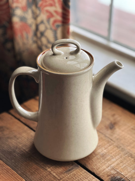 stoneware coffee pot with a softly speckled surface and brown trim