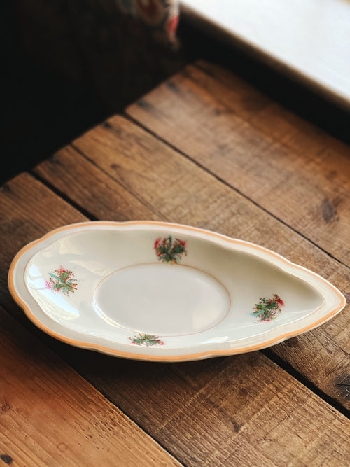 Decorative ceramic plate with floral patterns on a wooden surface