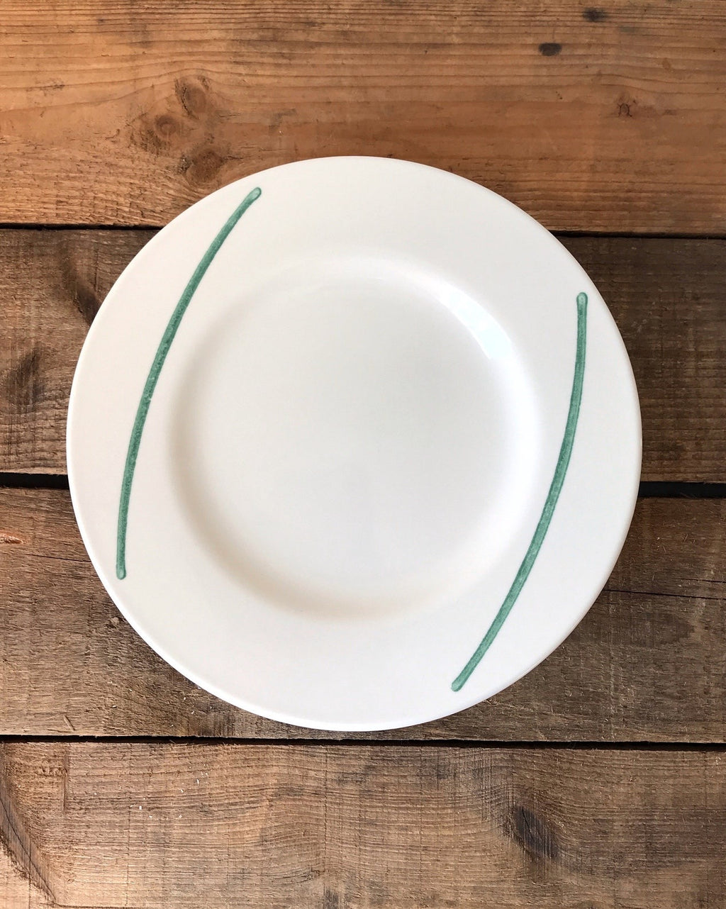 white stoneware plate with green brushstrokes