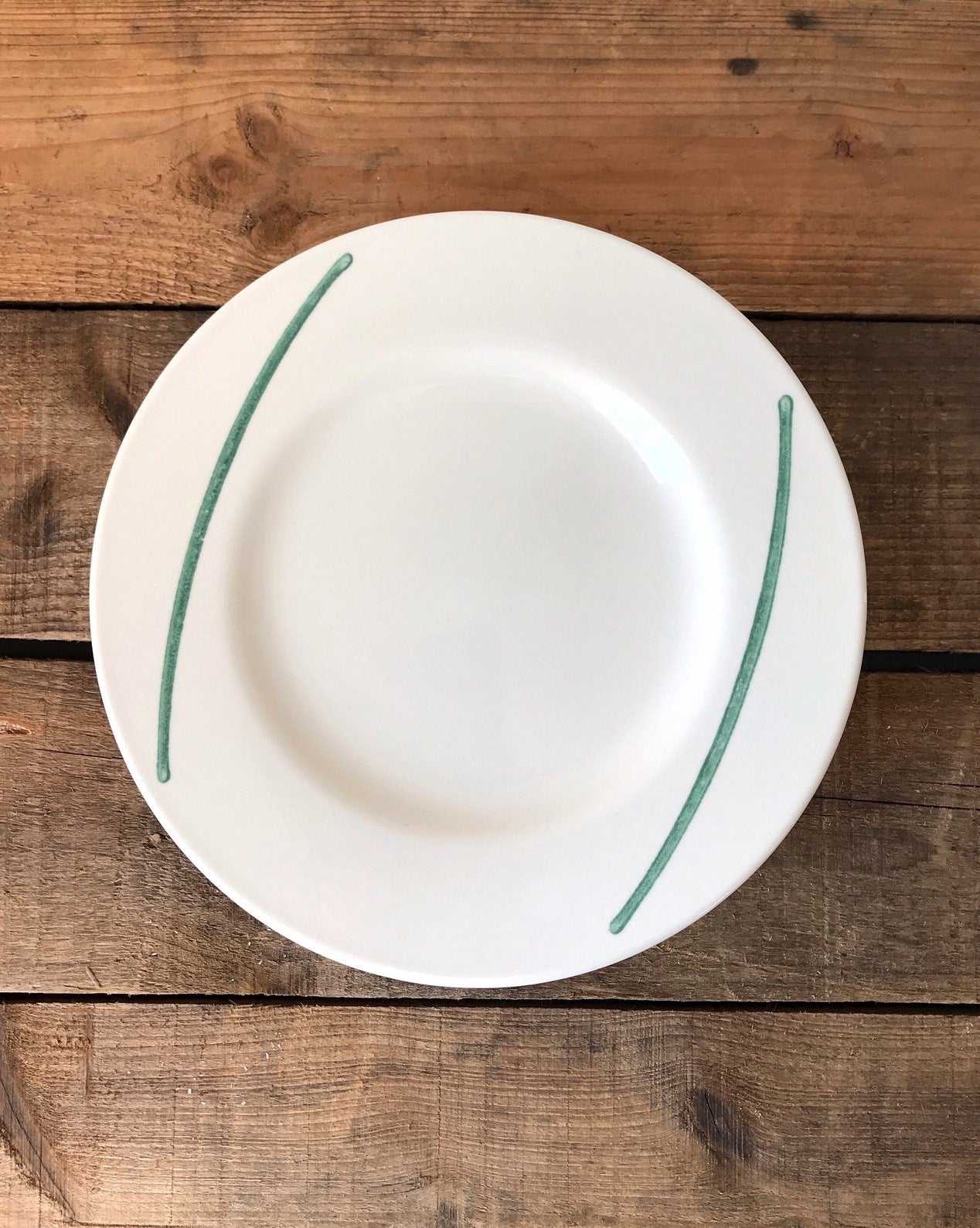 white stoneware plate with green brushstrokes
